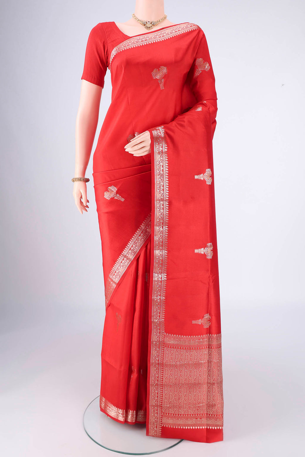 Red Banarasi Raw Silk Saree with Zari Butta on the body and Zari Border.  displayed on a mannequin