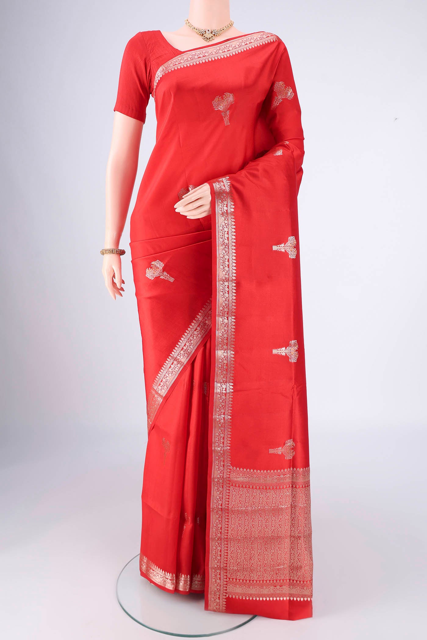 Red Banarasi Raw Silk Saree with Zari Butta on the body and Zari Border.  displayed on a mannequin