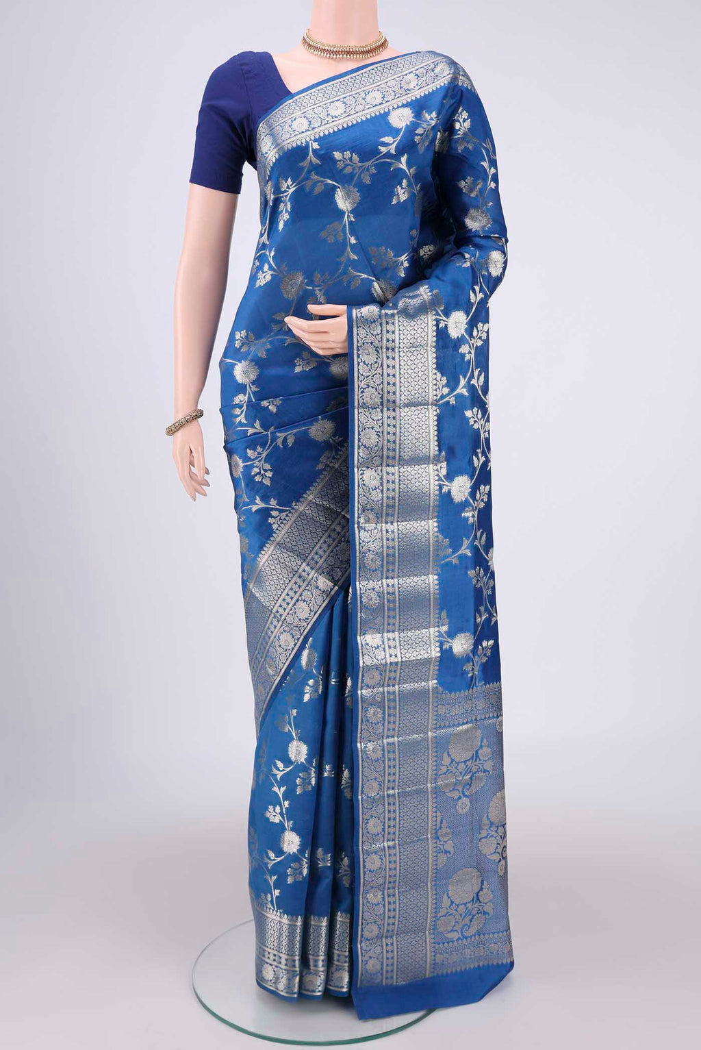 Blue Banarasi Raw Silk Saree with Zari Butta on the body and Zari Border.  displayed on a mannequin