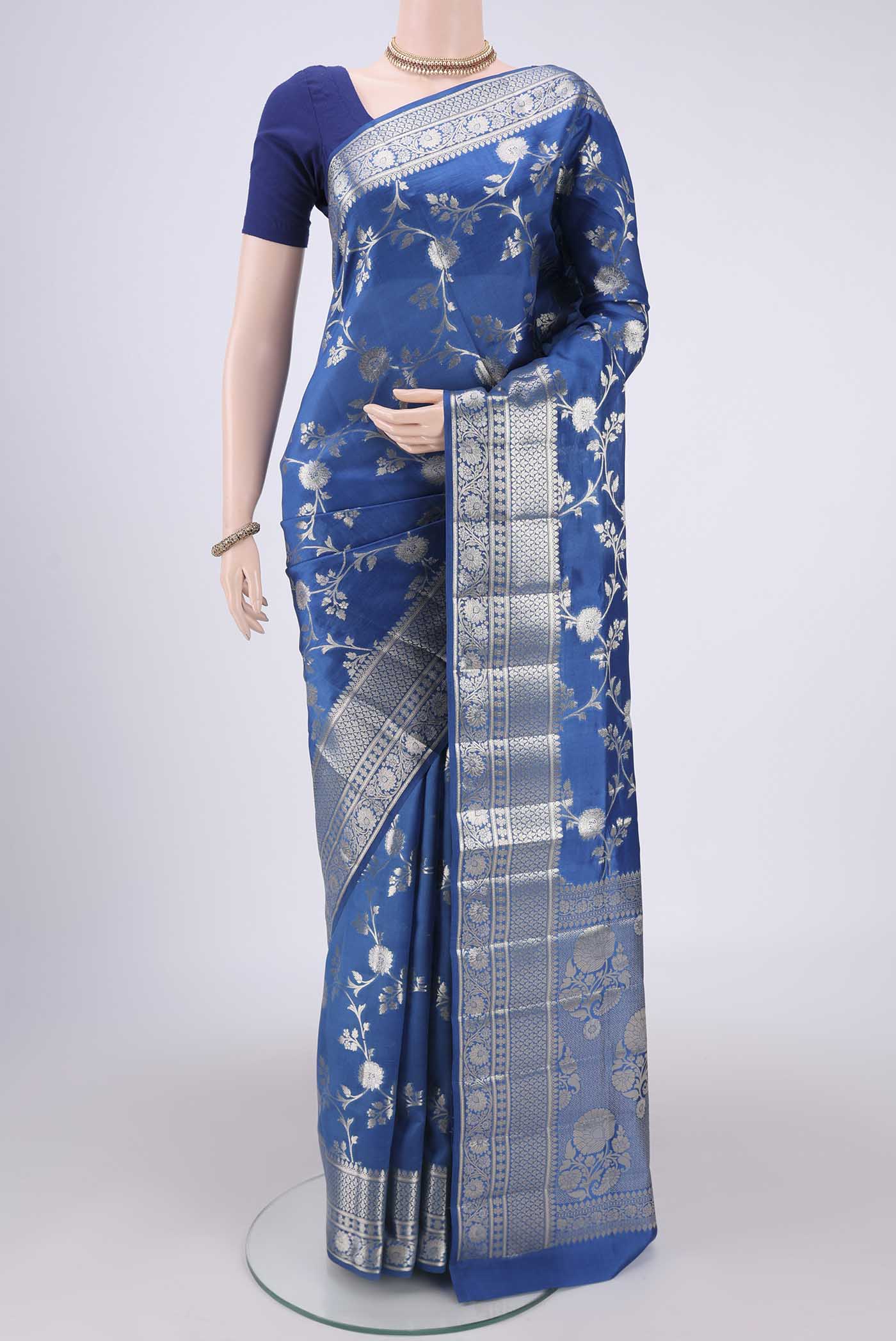 Blue Banarasi Raw Silk Saree with Zari Butta on the body and Zari Border.  displayed on a mannequin