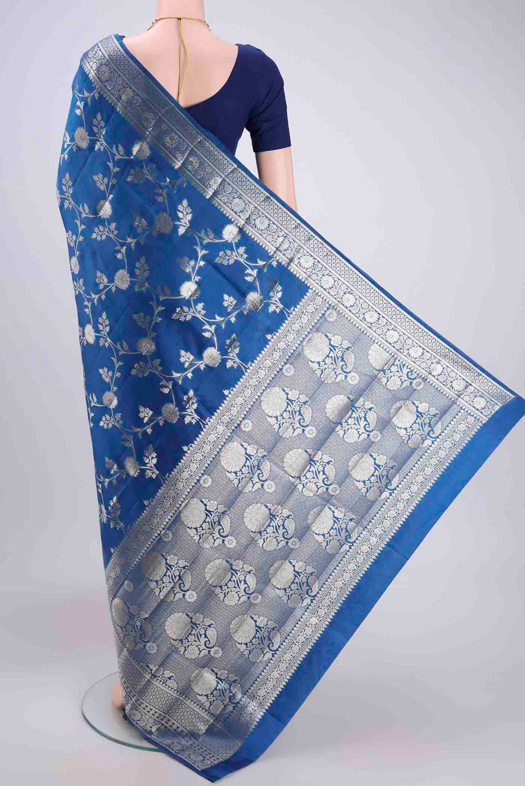 Flat view of Blue Banarasi Raw Silk Saree with Zari Butta on the body and Zari Border. 