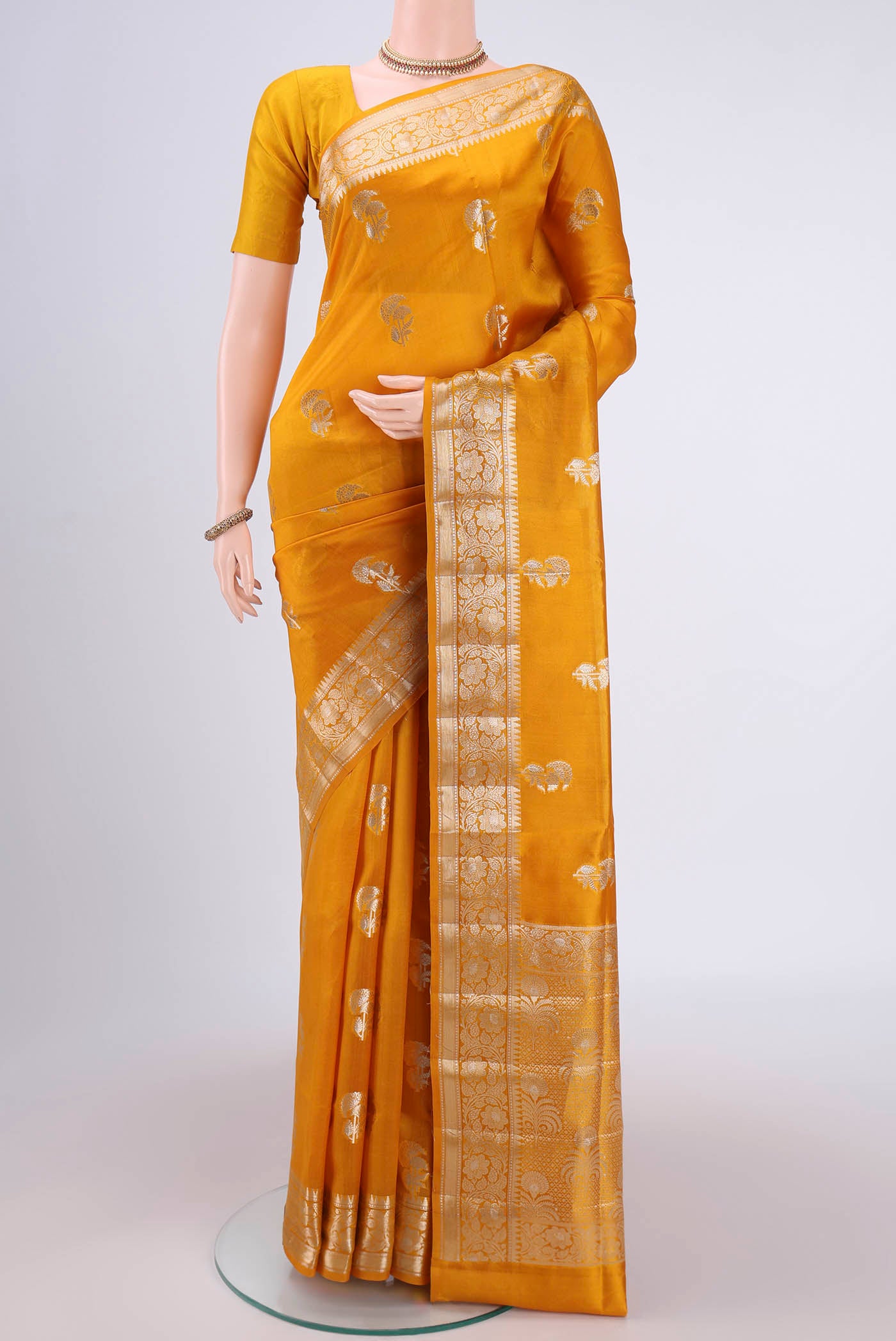 Yellow Banarasi Raw Silk Saree with Zari Butta on the body and Zari Border.  displayed on a mannequin