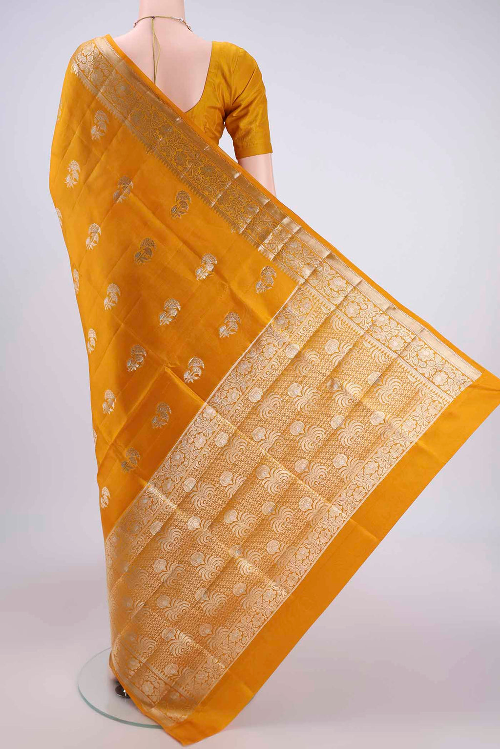 Flat view of Yellow Banarasi Raw Silk Saree with Zari Butta on the body and Zari Border. 