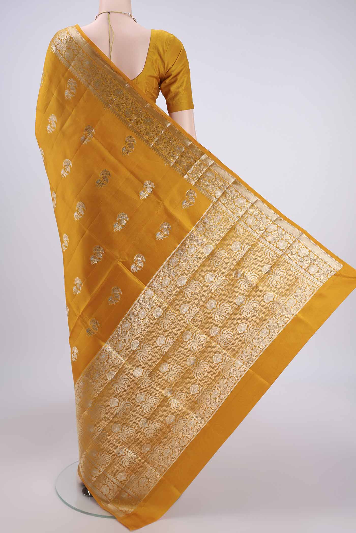 Flat view of Yellow Banarasi Raw Silk Saree with Zari Butta on the body and Zari Border. 