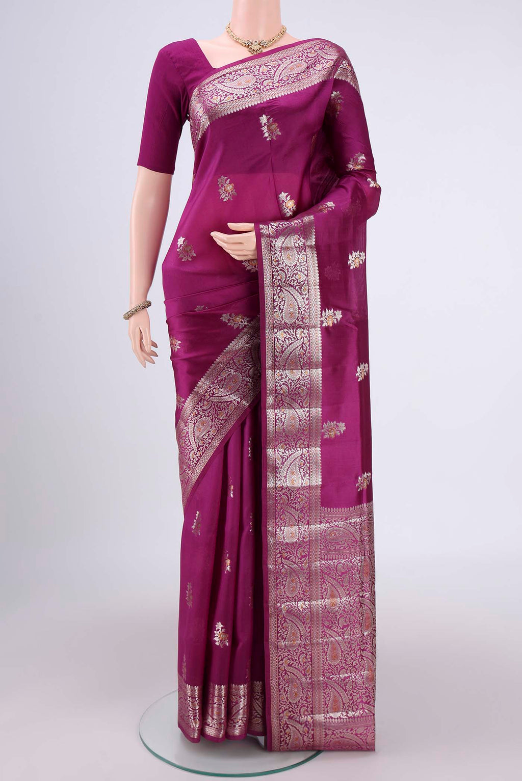 Magenta Banarasi Raw Silk Saree with Zari Brocade on the body and Zari Border.  displayed on a mannequin