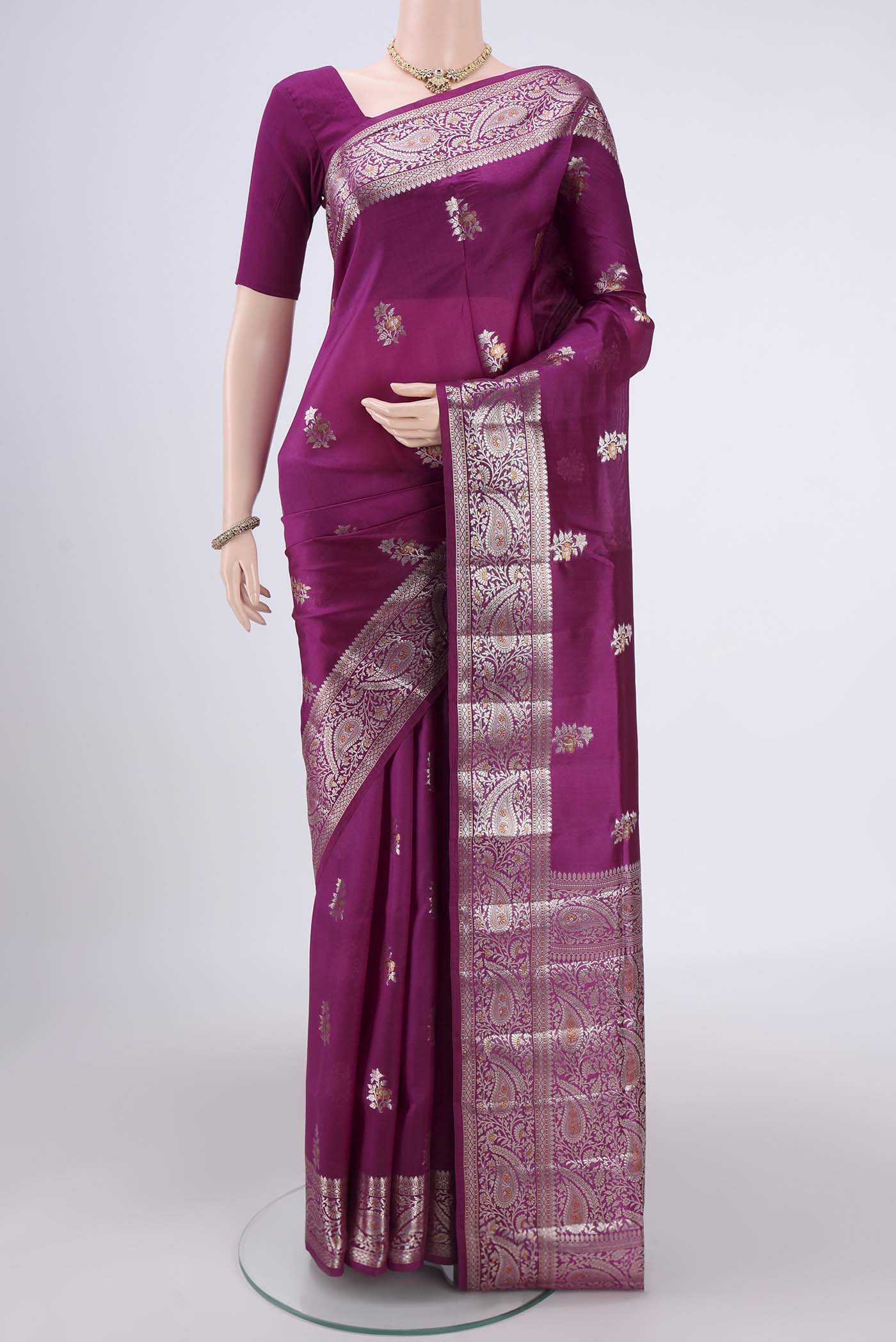 Magenta Banarasi Raw Silk Saree with Zari Brocade on the body and Zari Border.  displayed on a mannequin