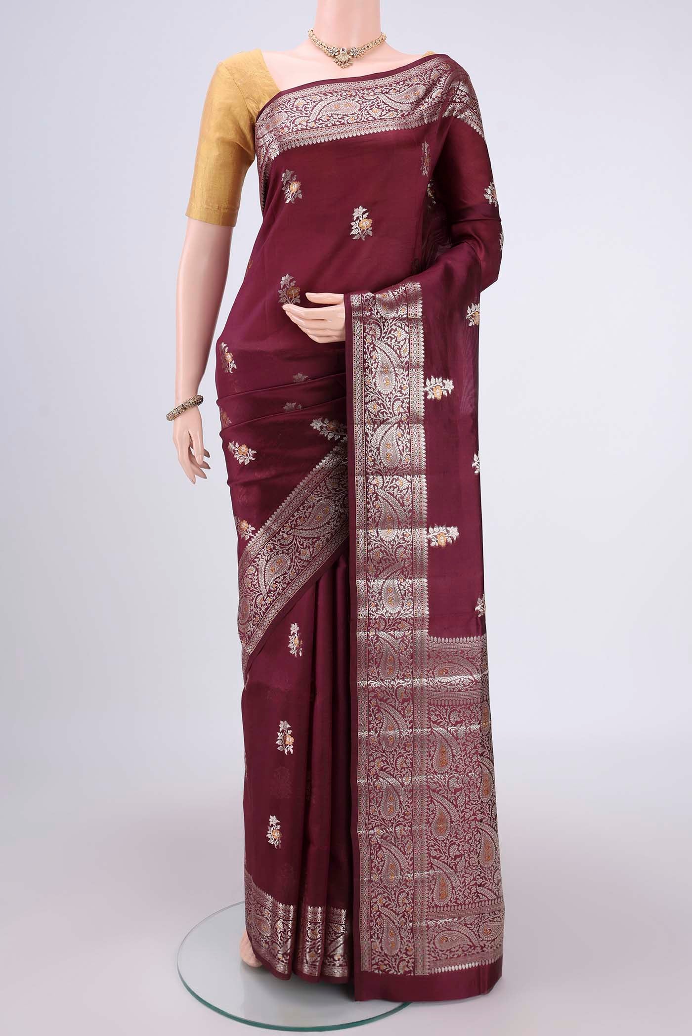 Burgundy Banarasi Raw Silk Saree with Zari Brocade on the body and Zari Border.  displayed on a mannequin