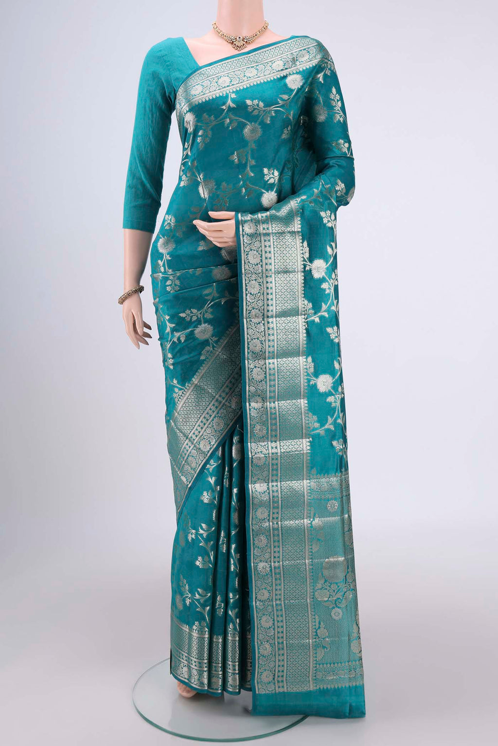 Peacock Blue Banarasi Raw Silk Saree with Zari Brocade on the body and Zari Border.  displayed on a mannequin