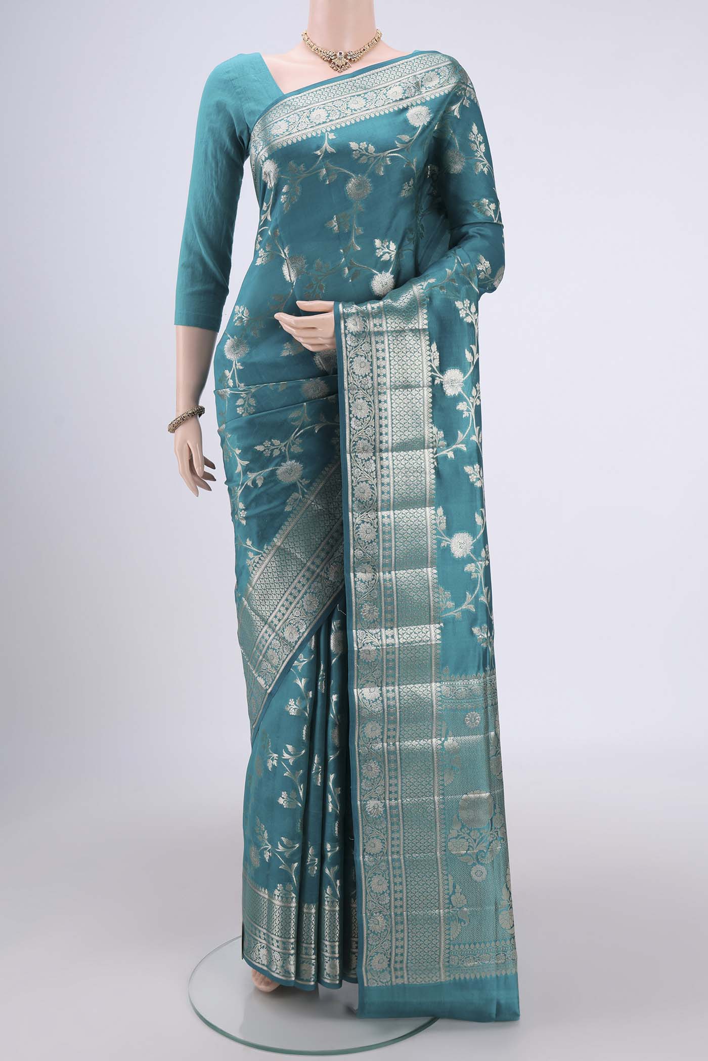 Peacock Blue Banarasi Raw Silk Saree with Zari Brocade on the body and Zari Border.  displayed on a mannequin