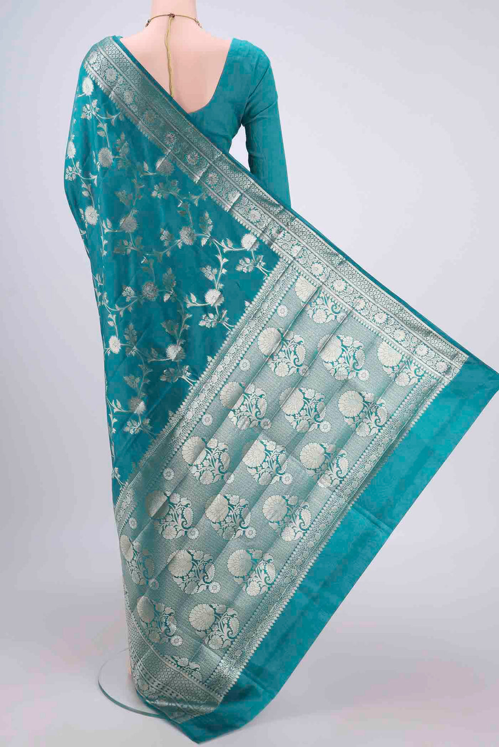 Flat view of Peacock Blue Banarasi Raw Silk Saree with Zari Brocade on the body and Zari Border. 