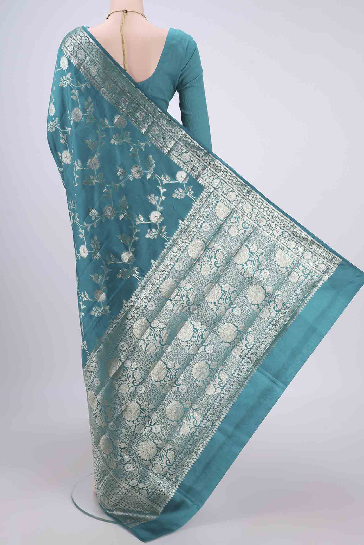 Flat view of Peacock Blue Banarasi Raw Silk Saree with Zari Brocade on the body and Zari Border. 
