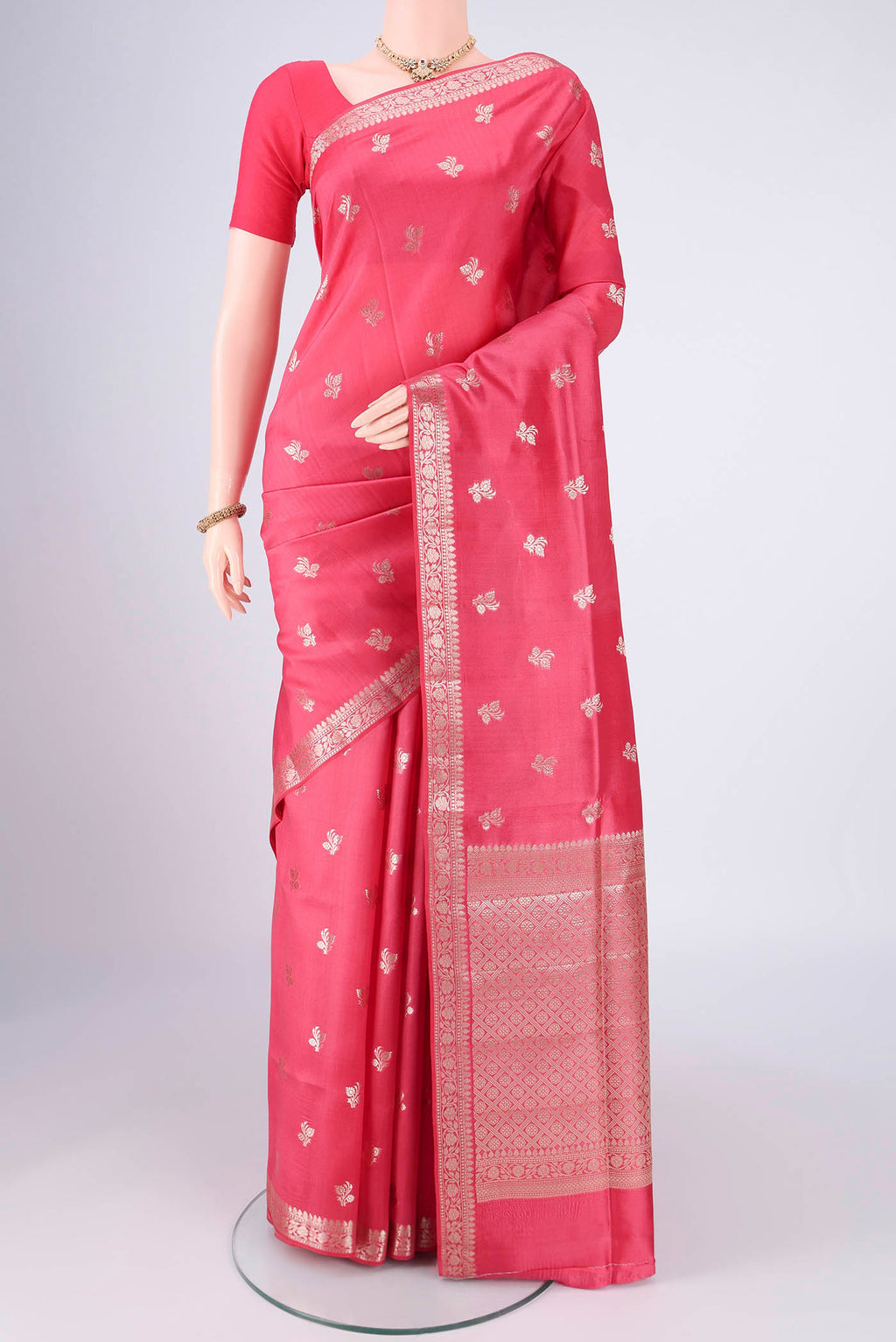 Peach Banarasi Raw Silk Saree with Zari Butta on the body and Zari Border.  displayed on a mannequin