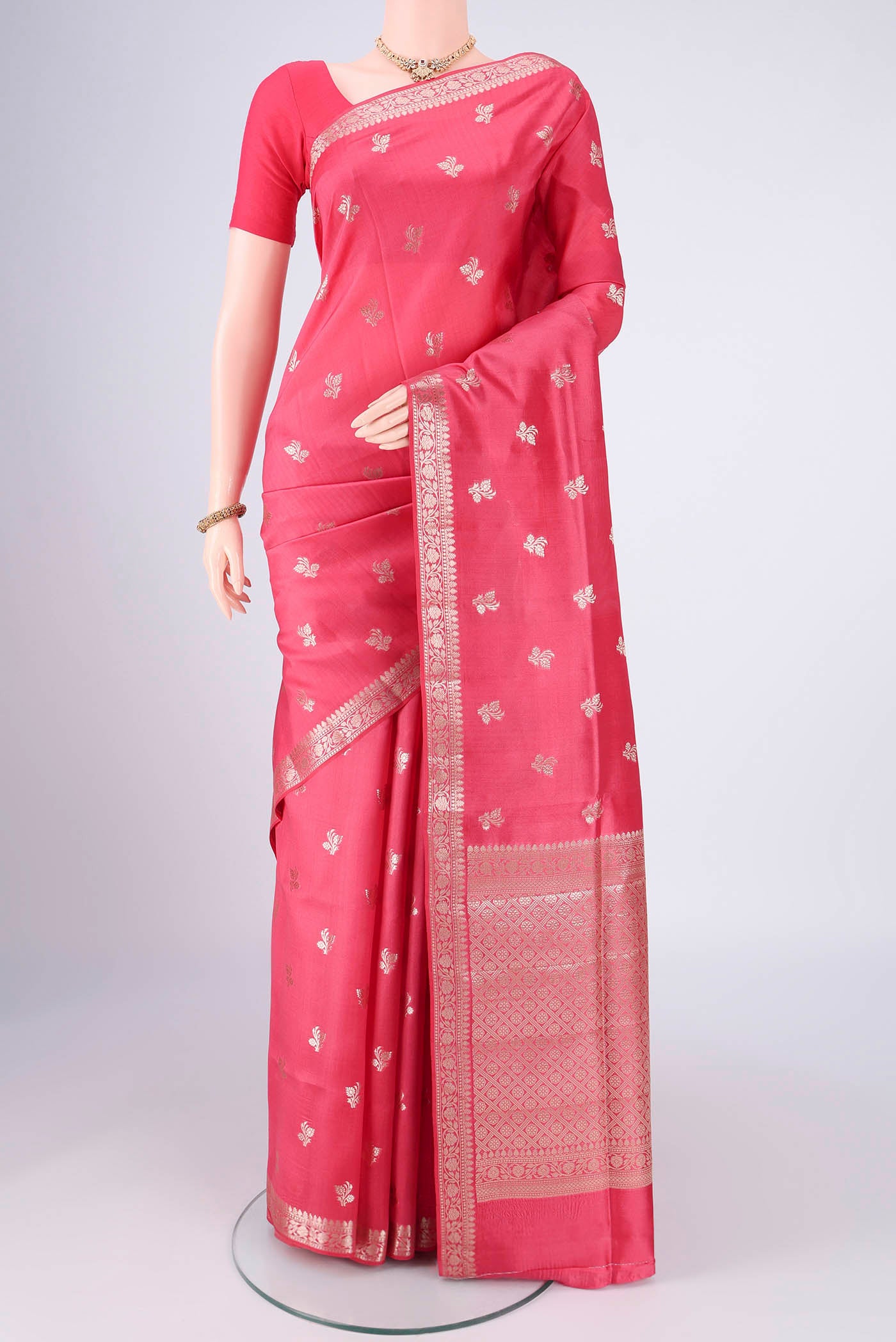 Peach Banarasi Raw Silk Saree with Zari Butta on the body and Zari Border.  displayed on a mannequin