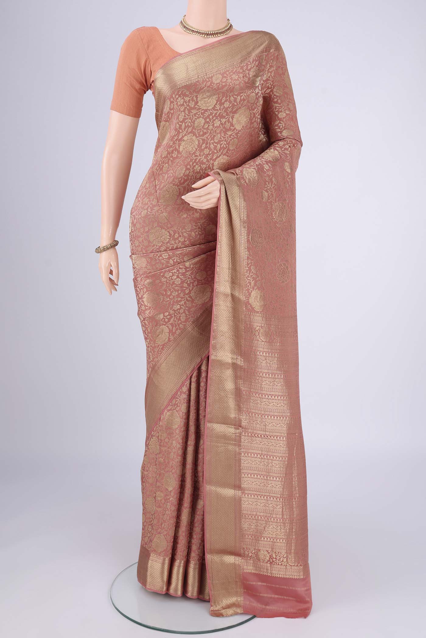 Peach Mysore Crepe Saree with Zari Brocade on the body and Zari Border.  displayed on a mannequin