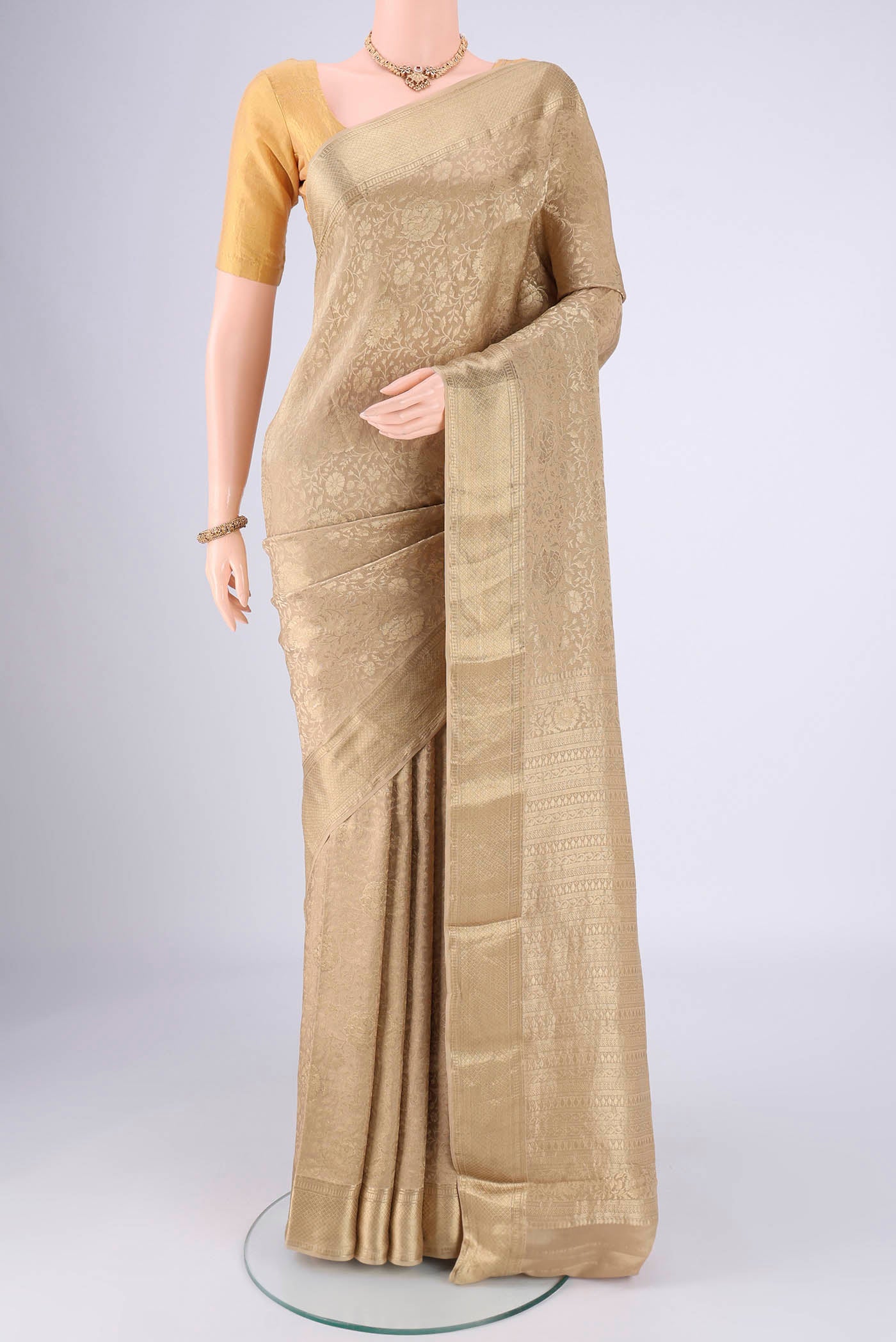 Dark Beige Mysore Crepe Saree with Zari Brocade on the body and Zari Border.  displayed on a mannequin