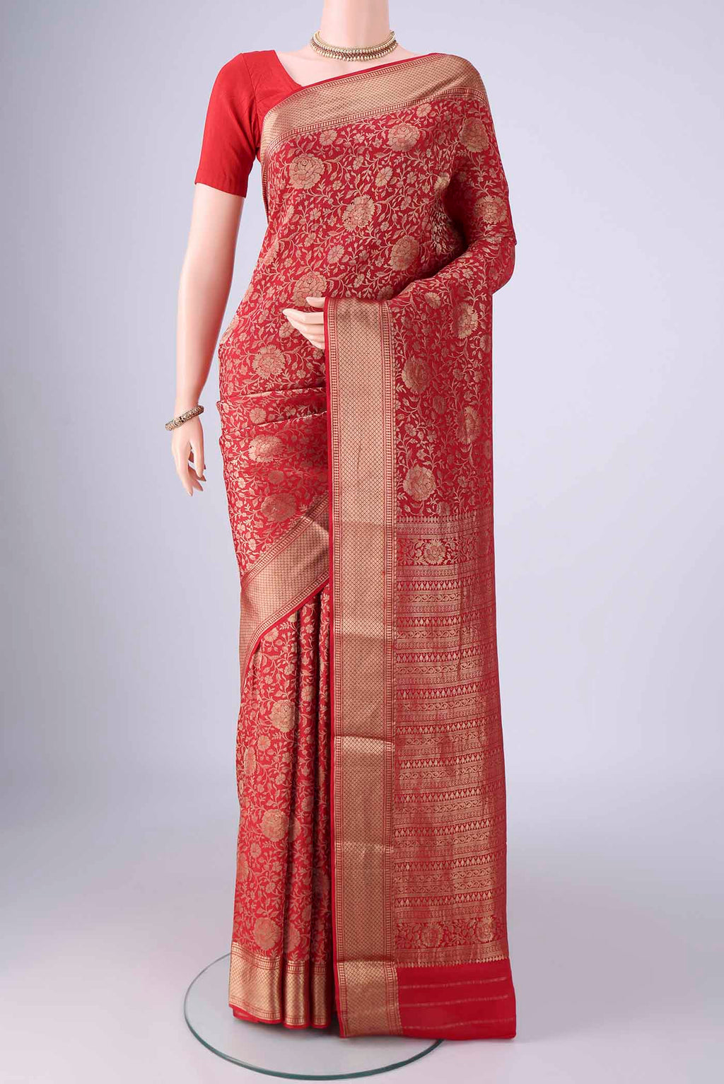Red Mysore Crepe Saree with Zari Brocade on the body and Zari Border.  displayed on a mannequin