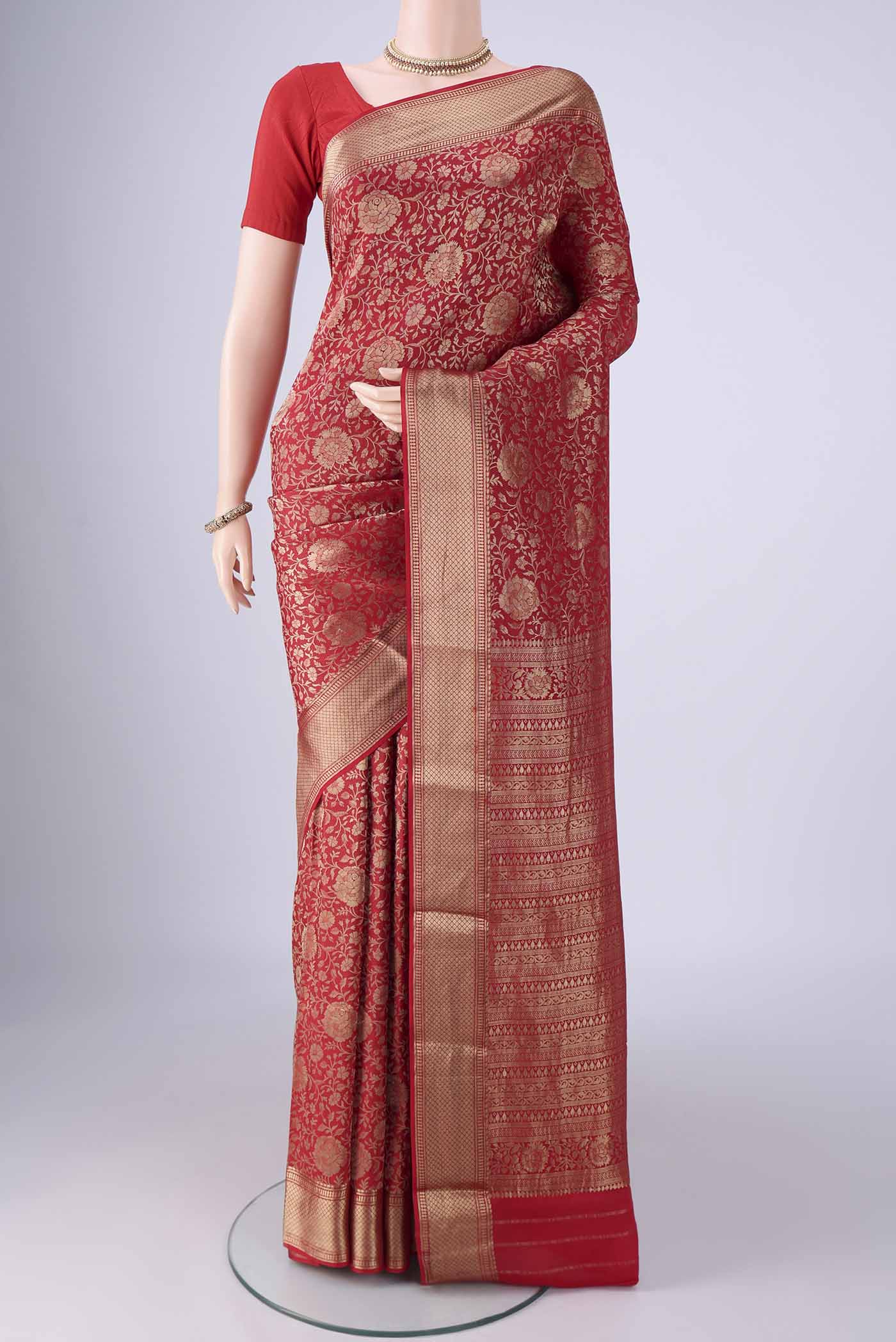 Red Mysore Crepe Saree with Zari Brocade on the body and Zari Border.  displayed on a mannequin
