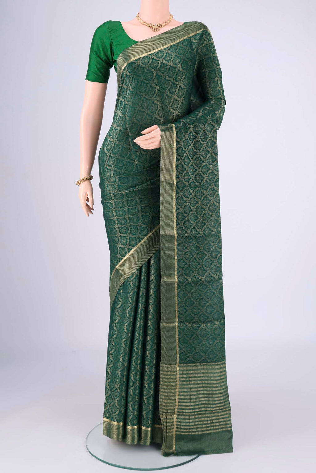 Bottle Green Mysore Crepe Saree with Zari Brocade on the body and Zari Border.  displayed on a mannequin
