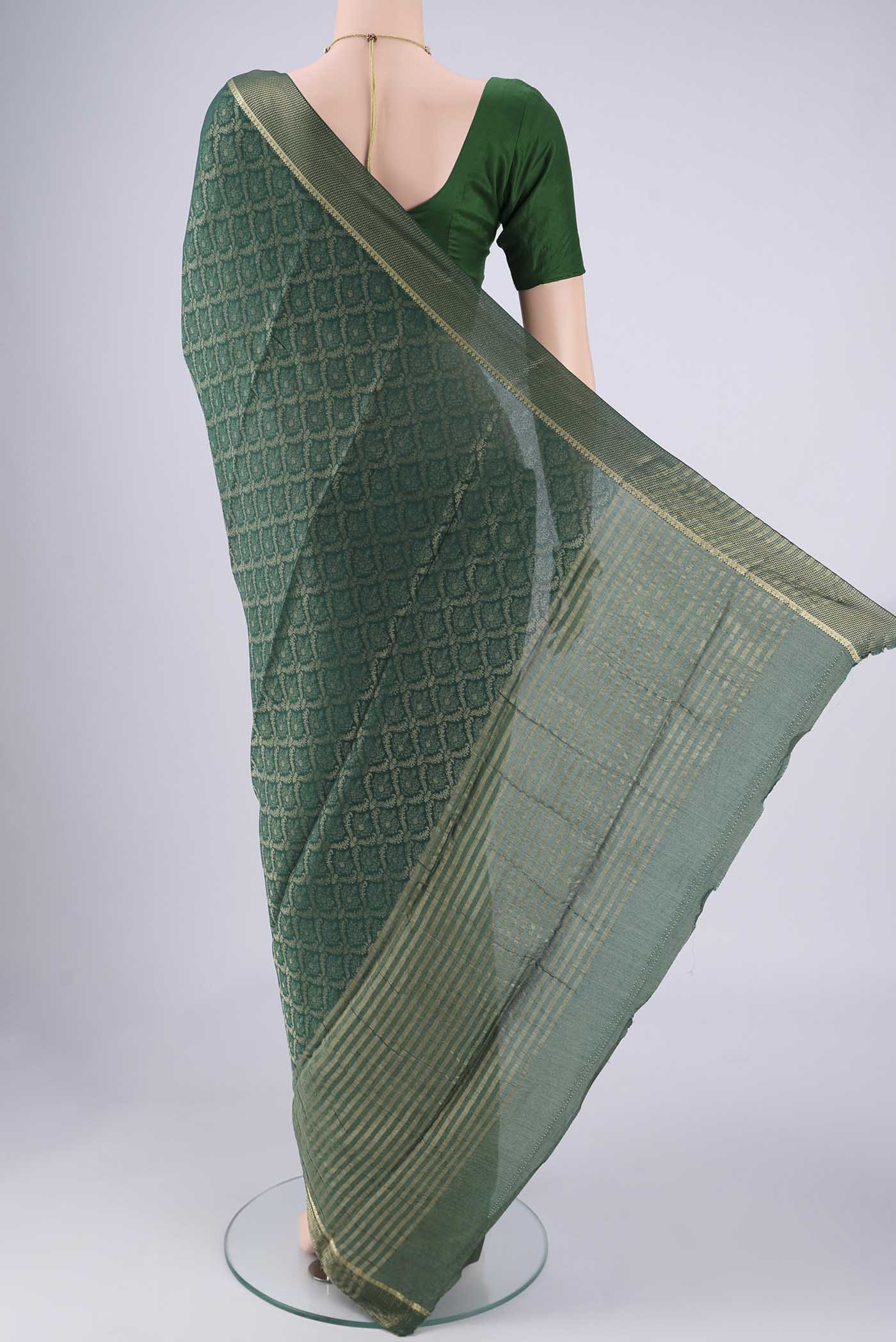 Flat view of Bottle Green Mysore Crepe Saree with Zari Brocade on the body and Zari Border. 
