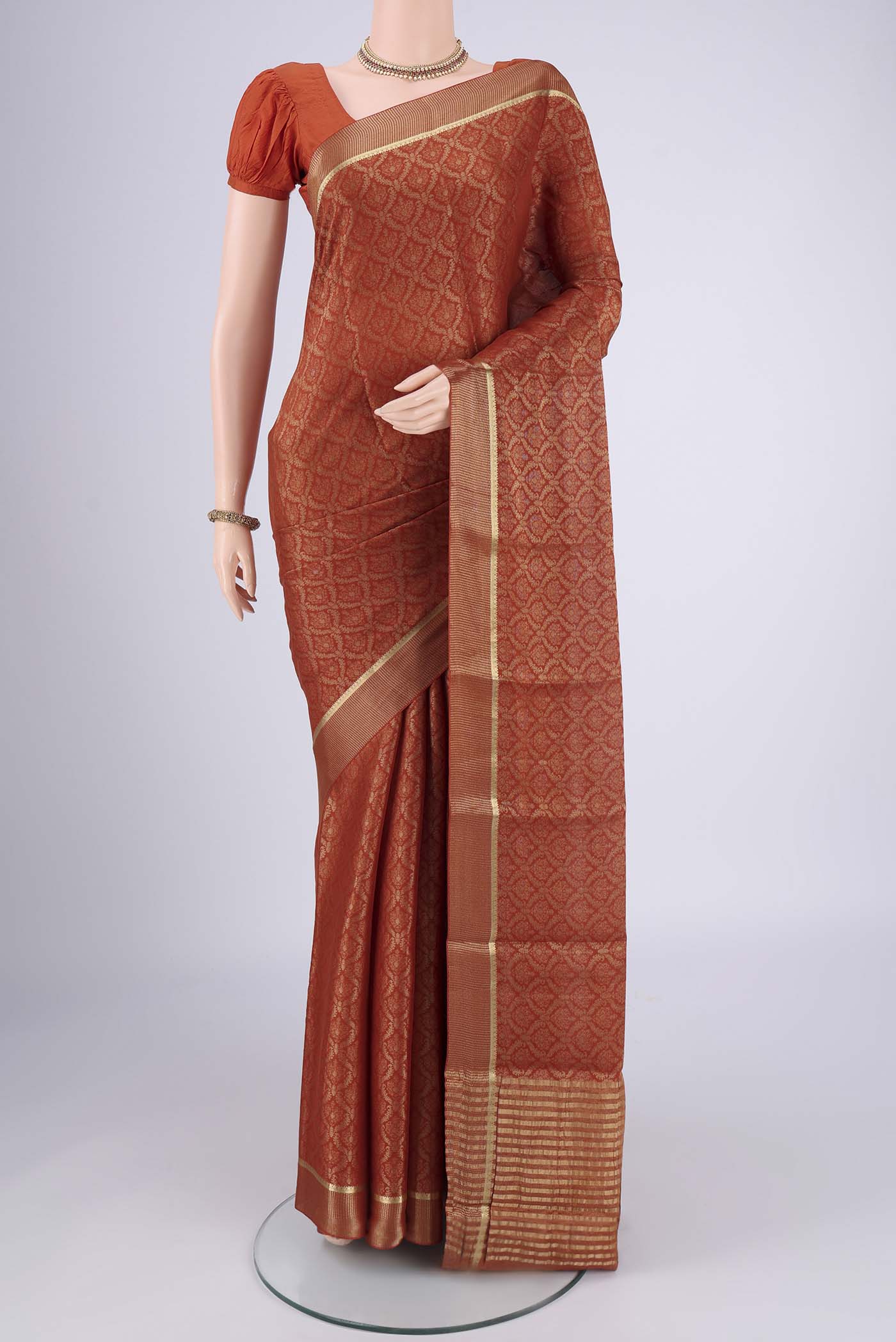 Rust Mysore Crepe Saree with Zari Brocade on the body and Zari Border.  displayed on a mannequin