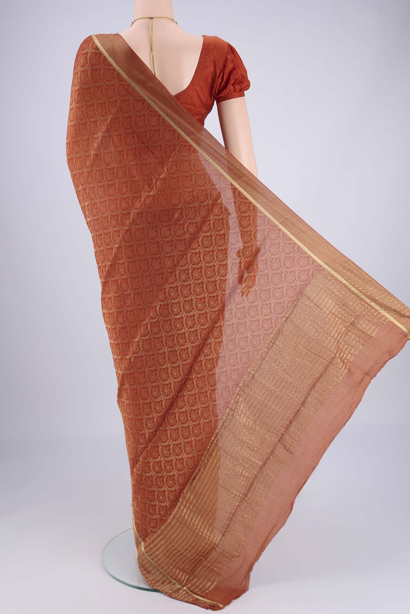 Flat view of Rust Mysore Crepe Saree with Zari Brocade on the body and Zari Border. 