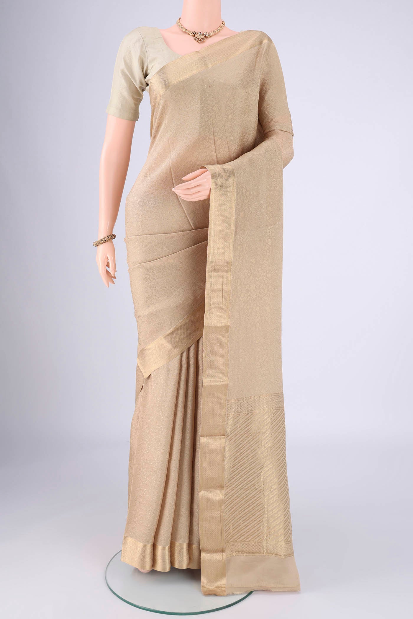 Beige Mysore Crepe Saree with Zari Brocade on the body and Zari Border.  displayed on a mannequin