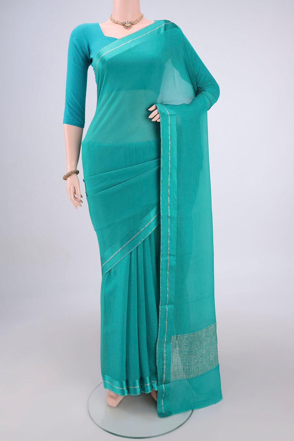 Turquoise Mysore Chiffon Saree with Plain Body and Satin Border.  displayed on a mannequin