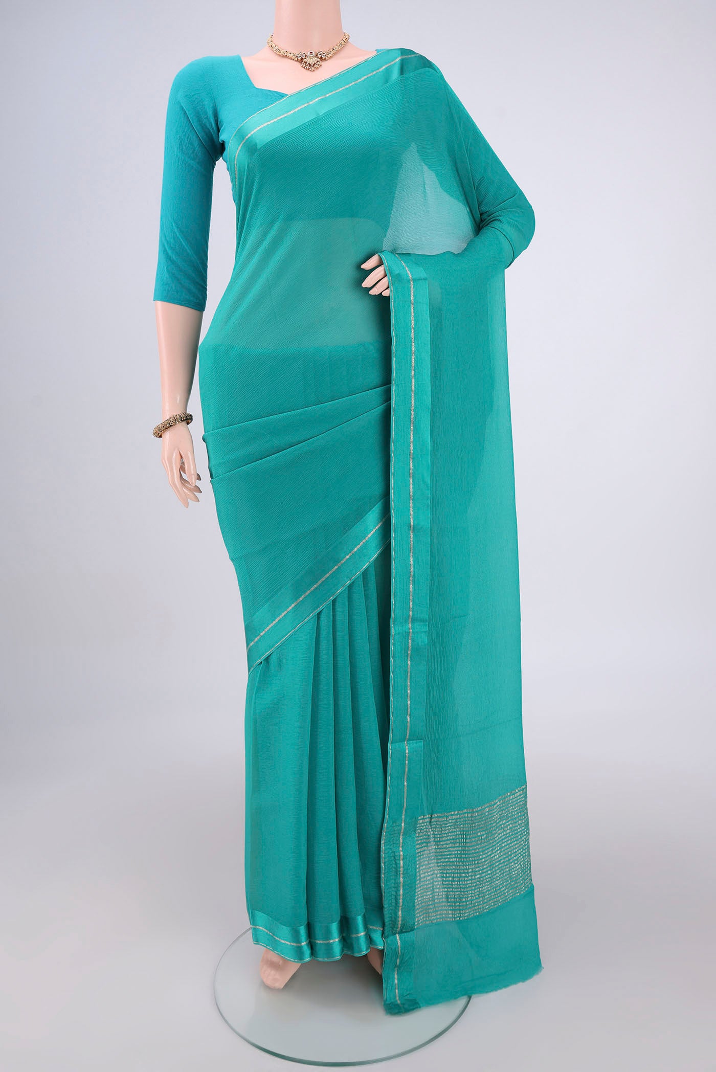 Turquoise Mysore Chiffon Saree with Plain Body and Satin Border.  displayed on a mannequin