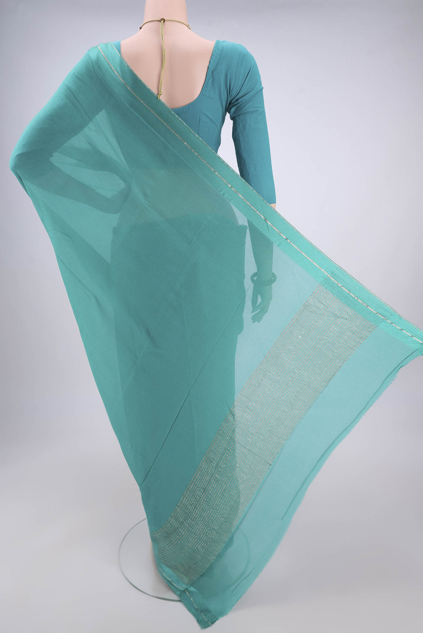 Flat view of Turquoise Mysore Chiffon Saree with Plain Body and Satin Border. 