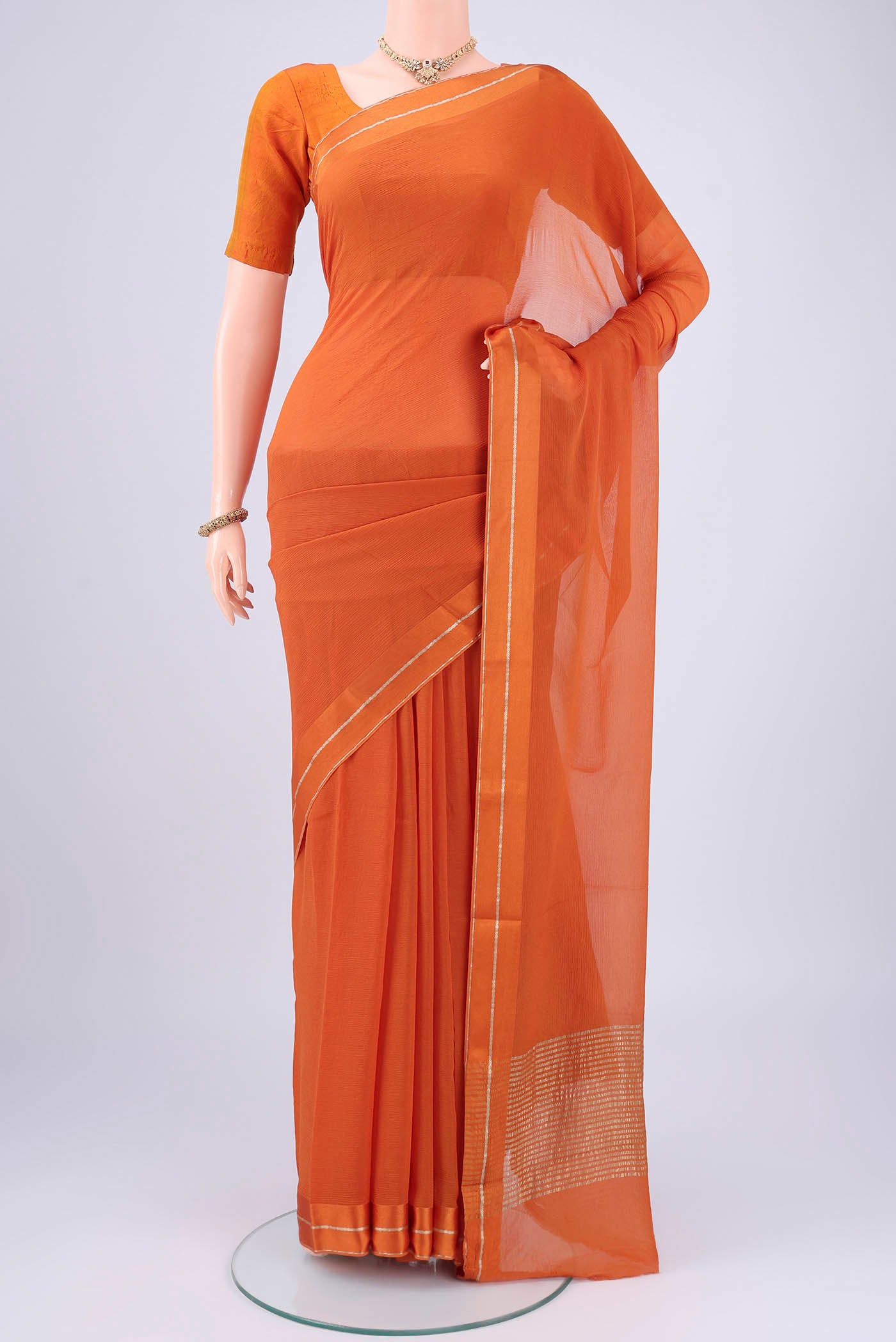 Rust Mysore Chiffon Saree with Plain Body and Satin Border.  displayed on a mannequin