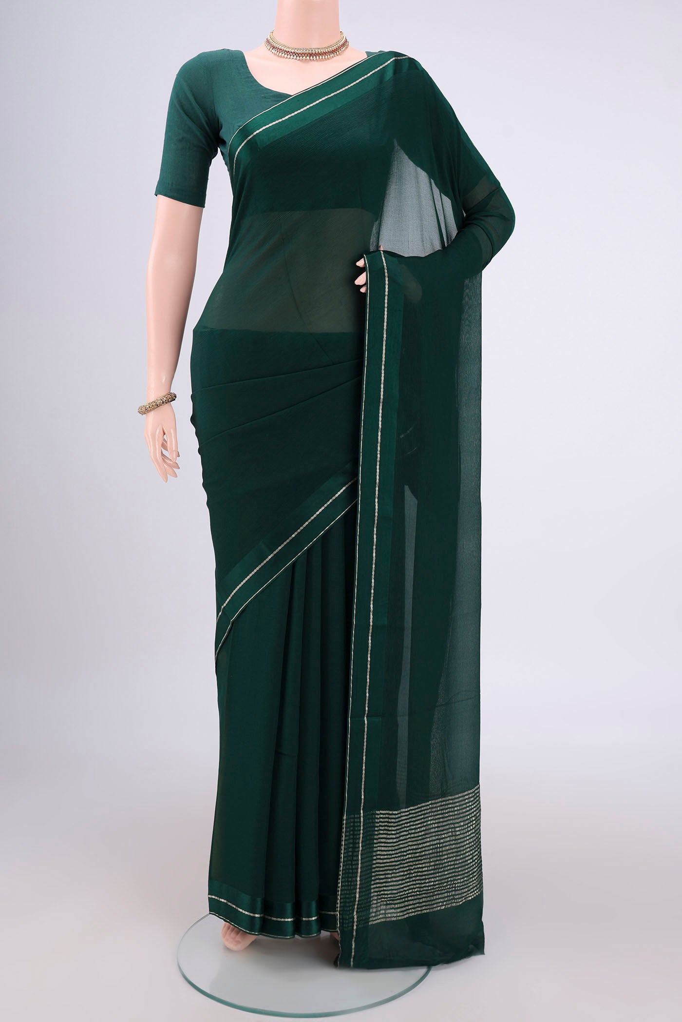 Bottle Green Mysore Chiffon Saree with Plain Body and Satin Border.  displayed on a mannequin