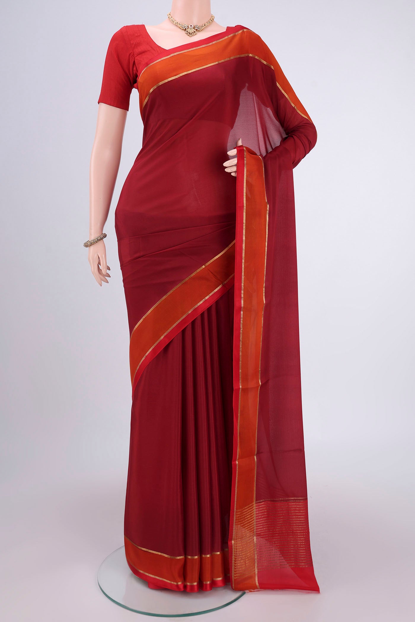 Maroon Mysore Crepe Saree with Plain Body and Zari Border.  displayed on a mannequin