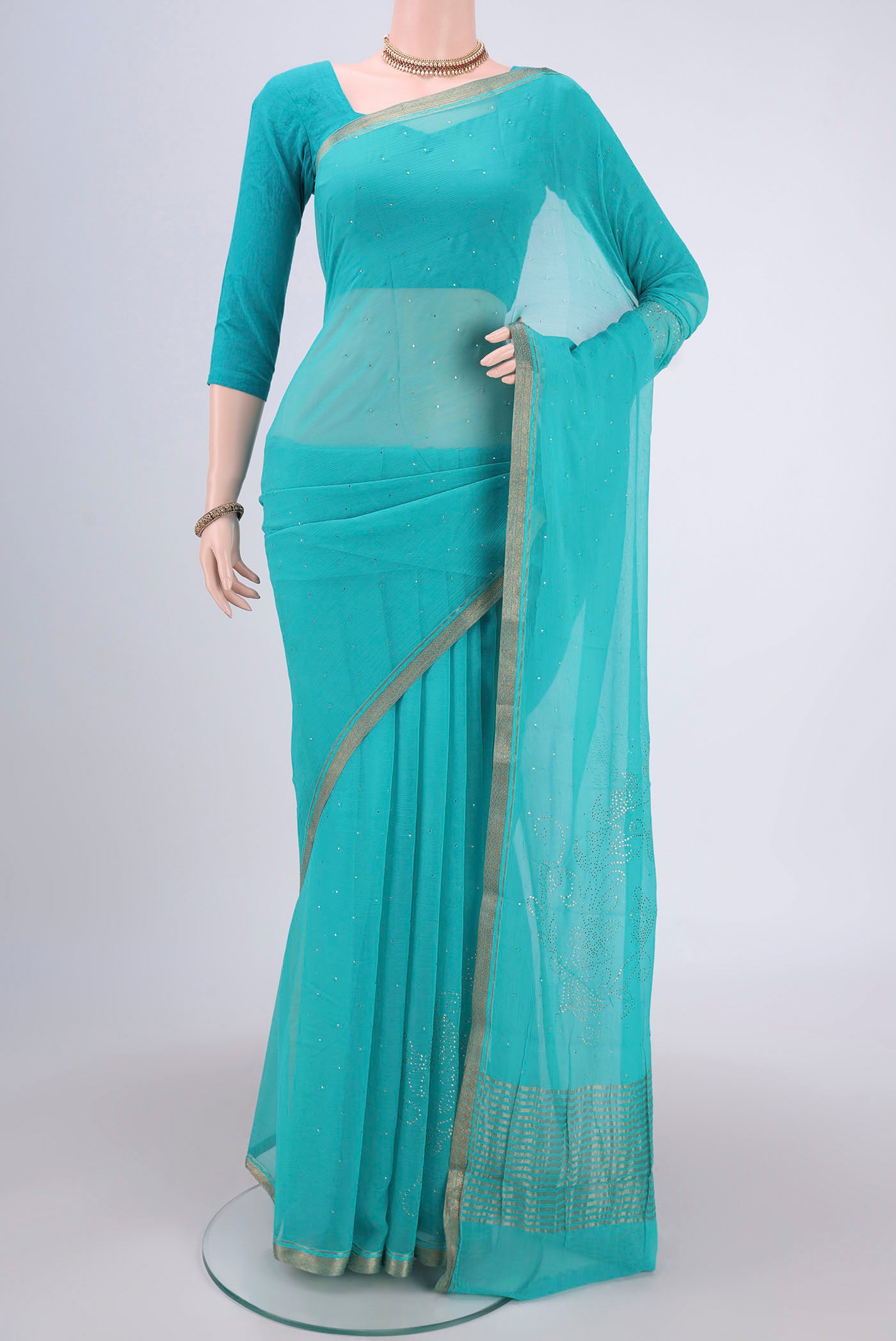 Turquoise Dual Tone Mysore Chiffon Saree with Embroidery on the body and Zari Border.  displayed on a mannequin