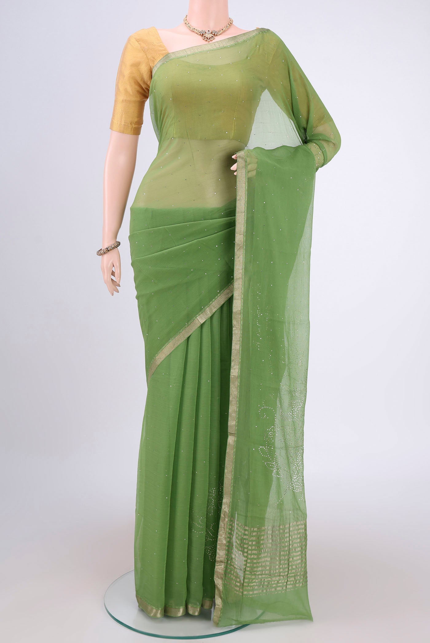 Light Green Mysore Chiffon Saree with Embroidery on the body and Zari Border.  displayed on a mannequin