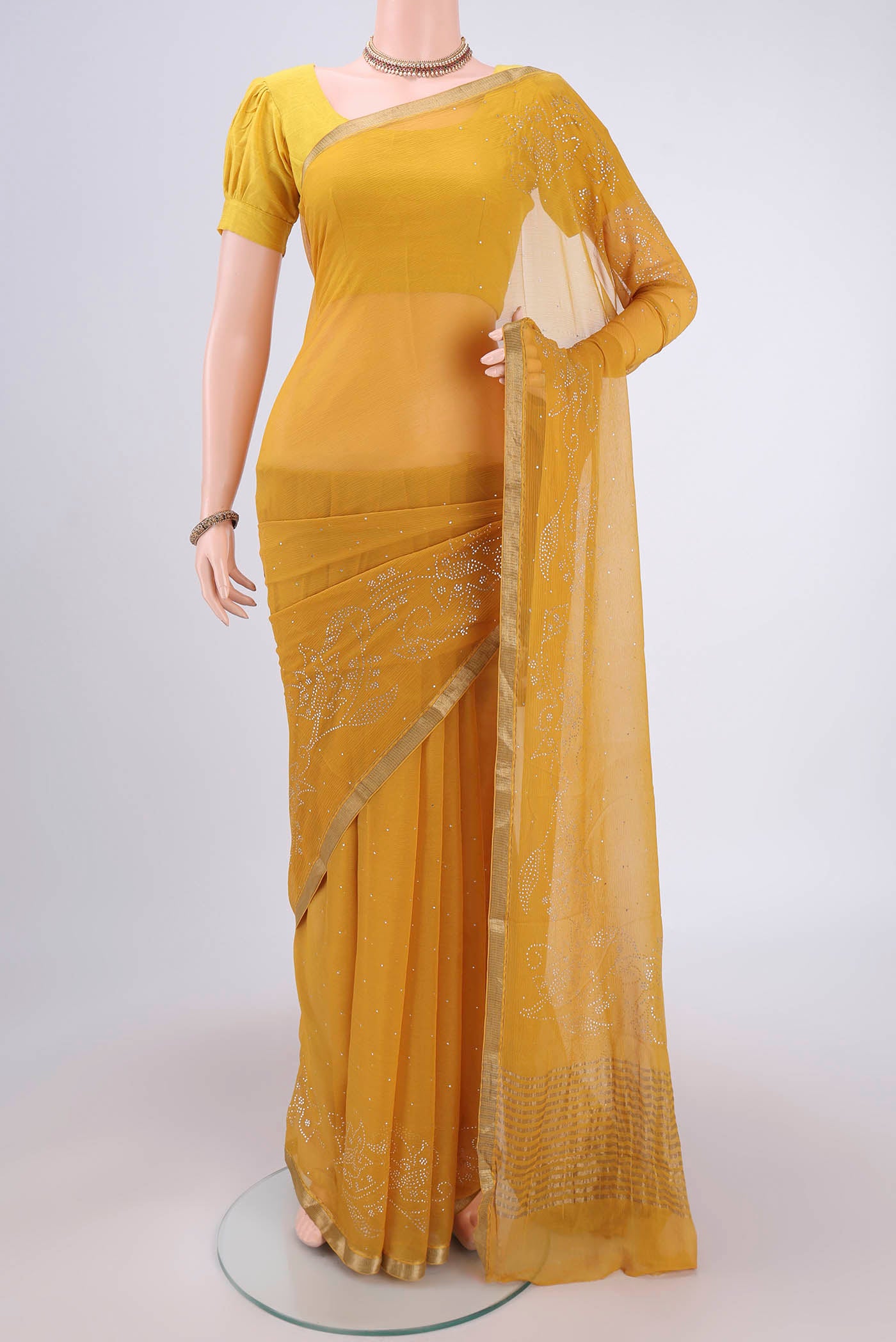 Mustard Dual Tone Mysore Chiffon Saree with Embroidery on the body and Zari Border.  displayed on a mannequin