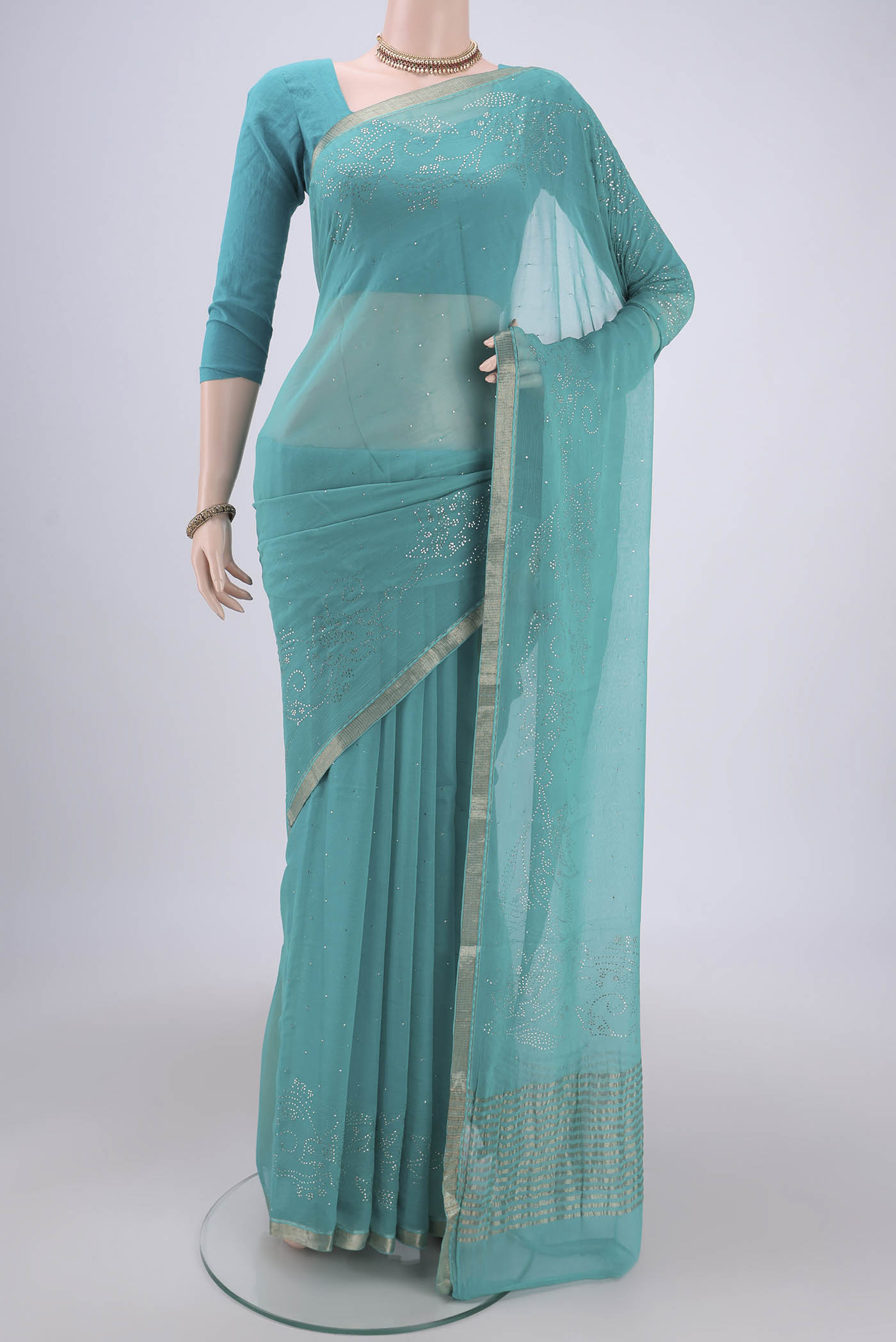Turquoise Dual Tone Mysore Chiffon Saree with Embroidery on the body and Zari Border.  displayed on a mannequin