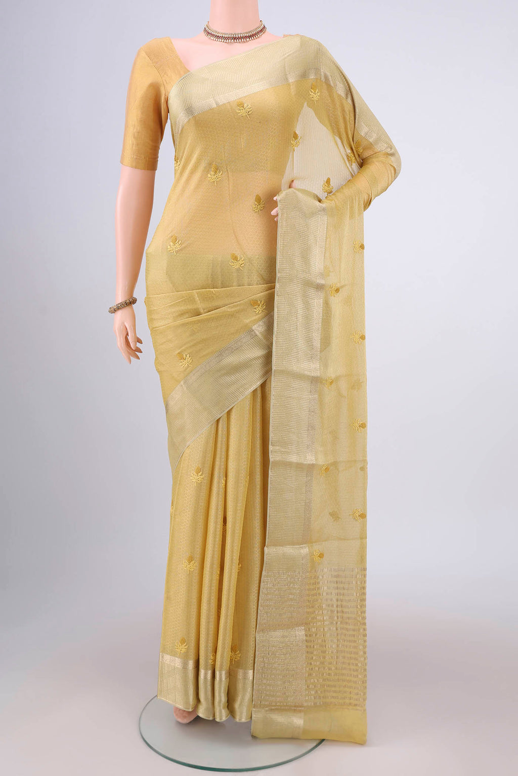 Yellow Mysore Georgette Saree with Embroidery on the body and Zari Border.  displayed on a mannequin