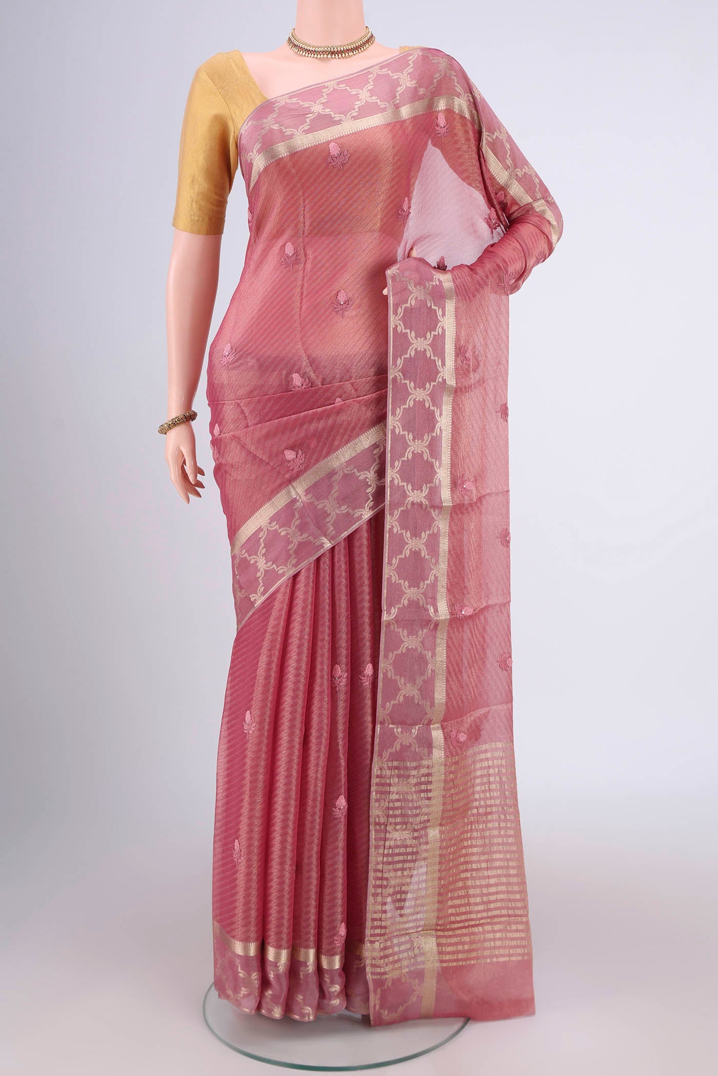 Rose Gold Mysore Georgette Saree with Embroidery on the body and Zari Border.  displayed on a mannequin