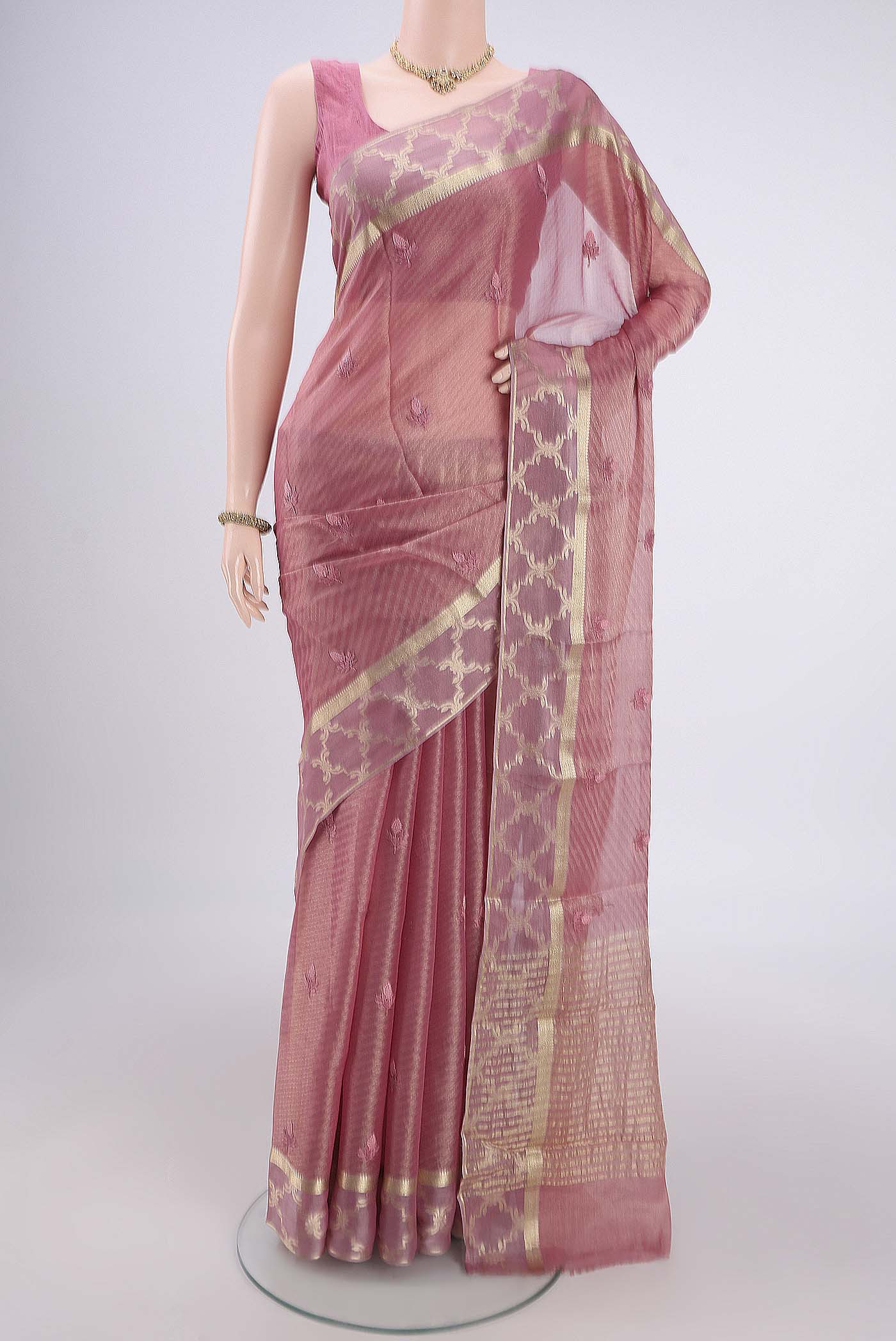 Rose Gold Mysore Georgette Saree with Embroidery on the body and Zari Border.  displayed on a mannequin