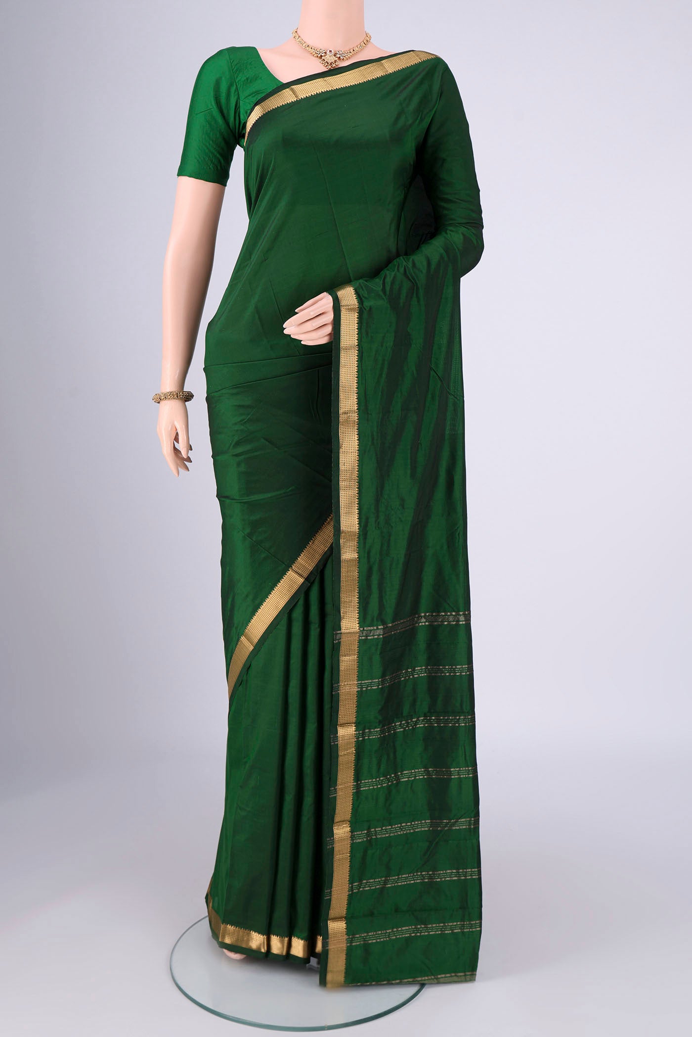 Bottle Green Blended Bangalore Silk Saree with Plain Body and Zari Border.  displayed on a mannequin