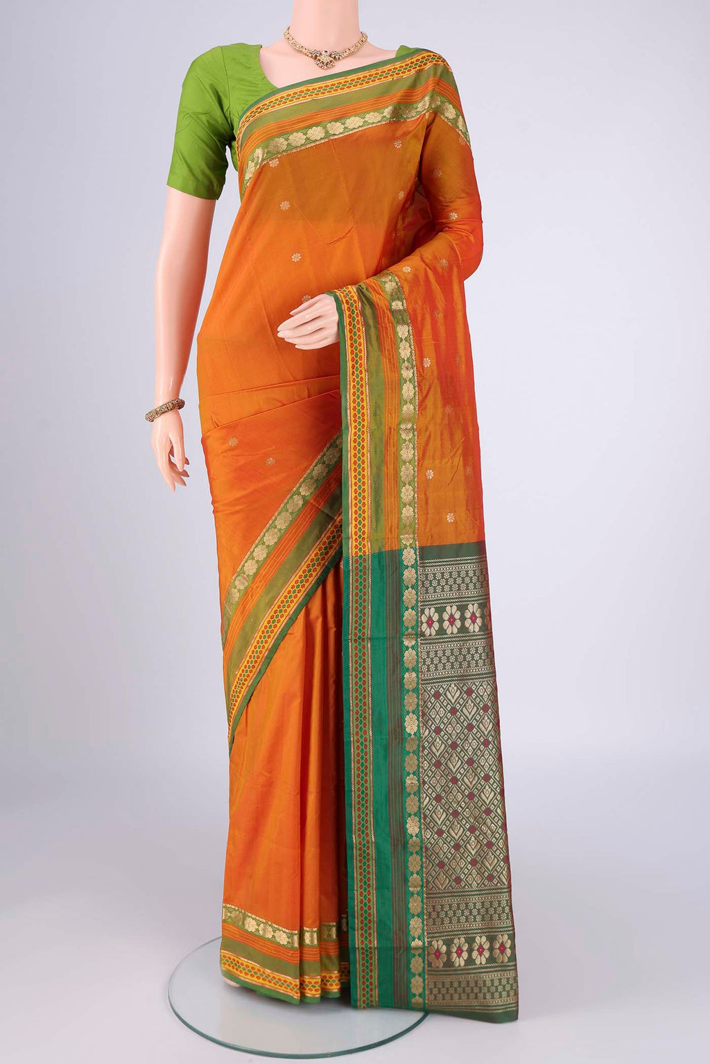 Brick Orange Blended Bangalore Silk Saree with Jacquard design on the body and Zari Border.  displayed on a mannequin