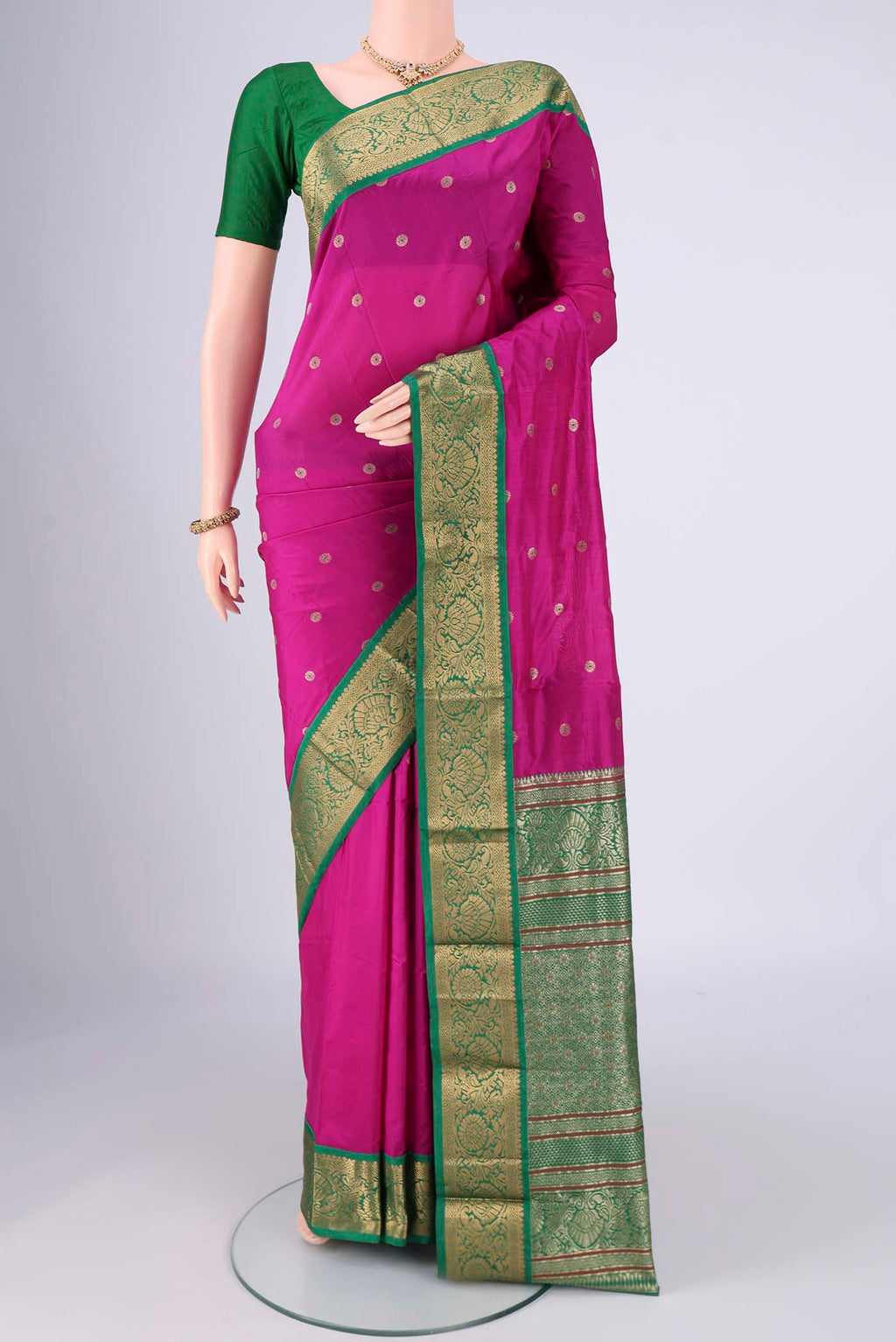 Rani Pink Blended Bangalore Silk Saree with Zari And Thread Butta on the body and Zari Border.  displayed on a mannequin