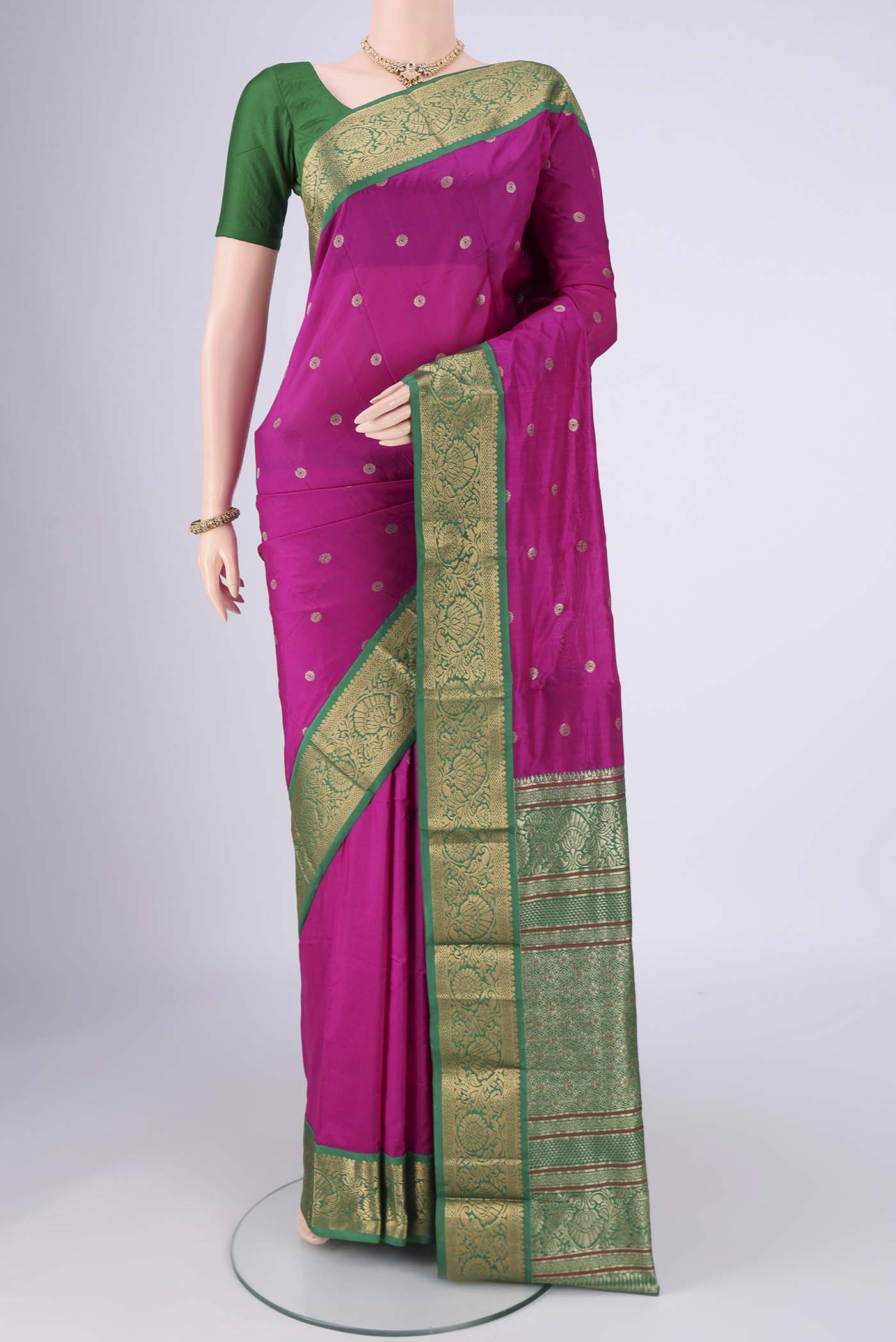 Rani Pink Blended Bangalore Silk Saree with Zari And Thread Butta on the body and Zari Border.  displayed on a mannequin