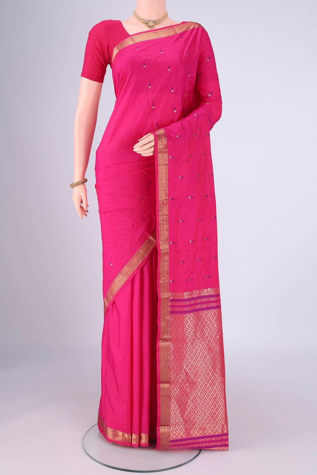Rani Pink Blended Bangalore Silk Saree with Zari And Thread Butta on the body and Zari Border.  displayed on a mannequin