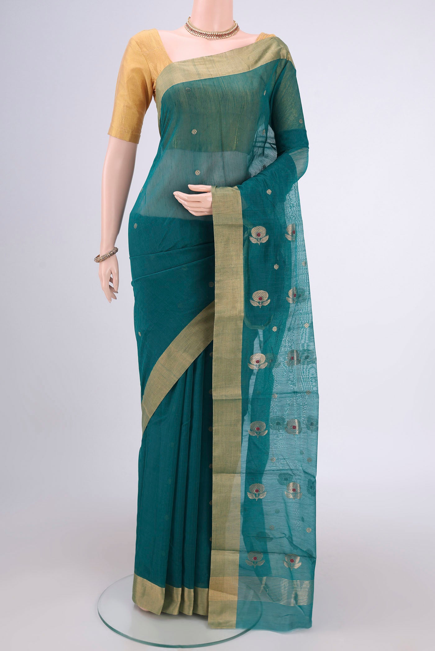 Green Chanderi Silk Cotton Saree with Zari And Thread Butta on the body and Zari Border.  displayed on a mannequin