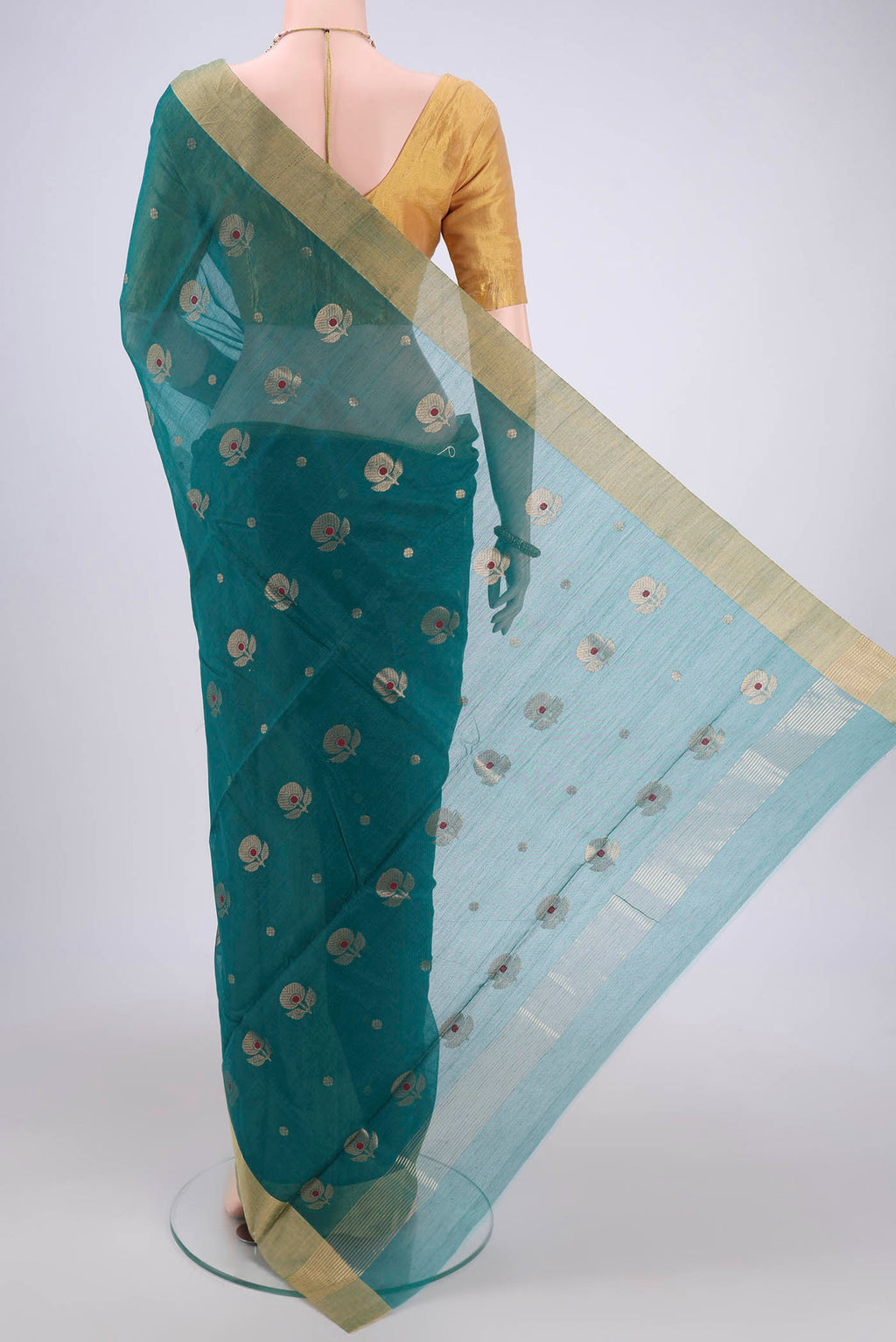 Flat view of Green Chanderi Silk Cotton Saree with Zari And Thread Butta on the body and Zari Border. 