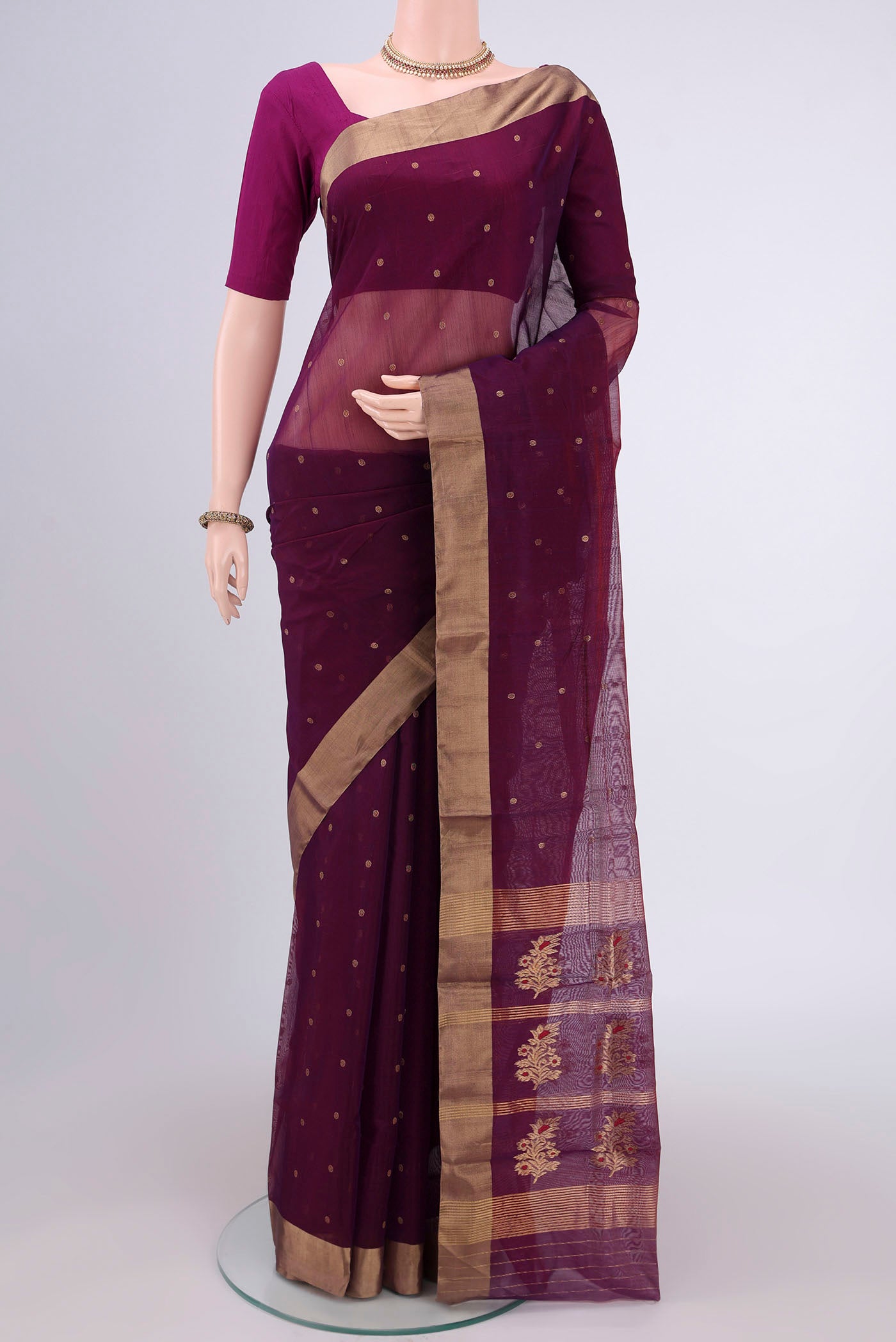 Magenta Chanderi Silk Cotton Saree with Zari Butta on the body and Zari Border.  displayed on a mannequin