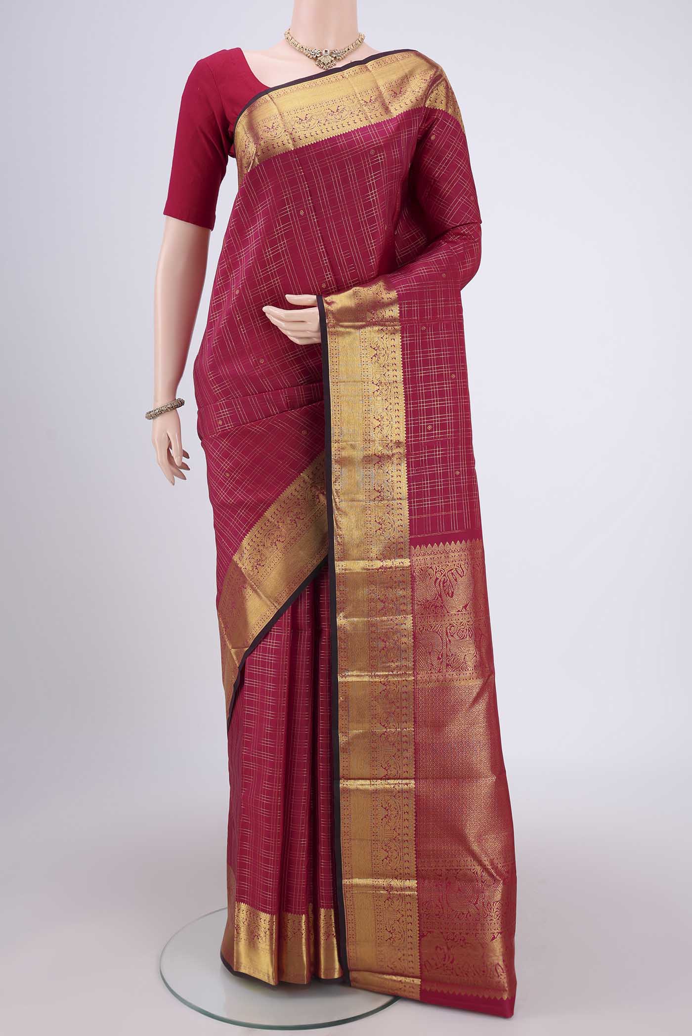 Maroon Dual Tone Kanjivaram Silk Saree with Checked design on the body and Zari Border.  displayed on a mannequin
