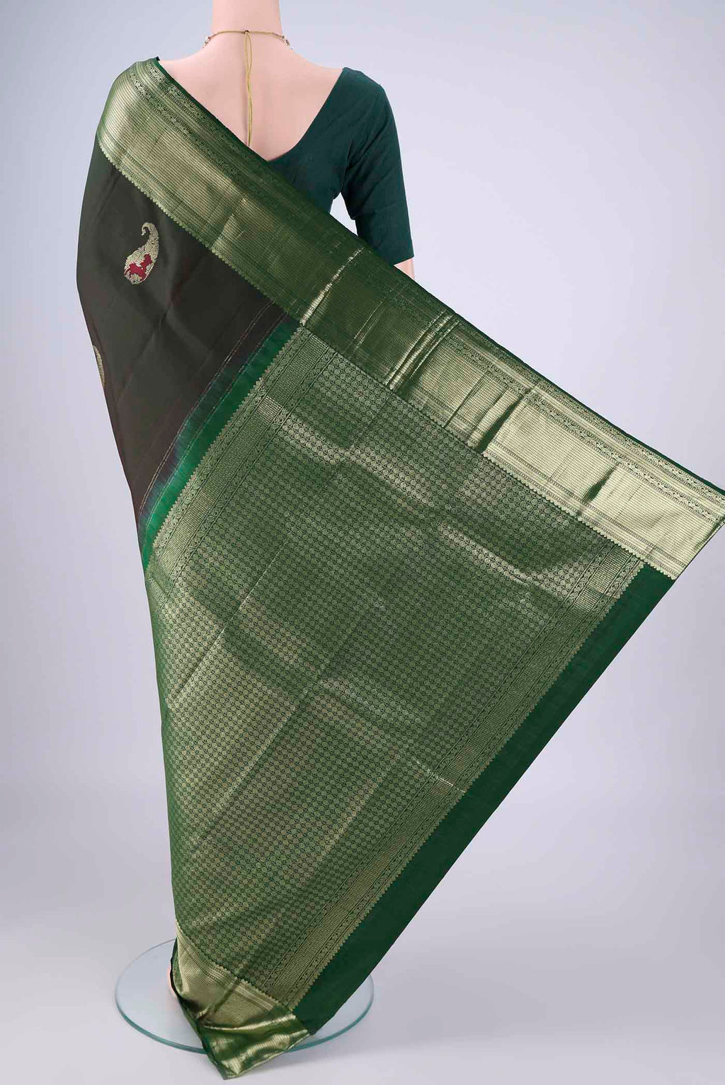 Flat view of Bottle Green Kanjivaram Silk Saree with Zari Butta on the body and Zari Border. 