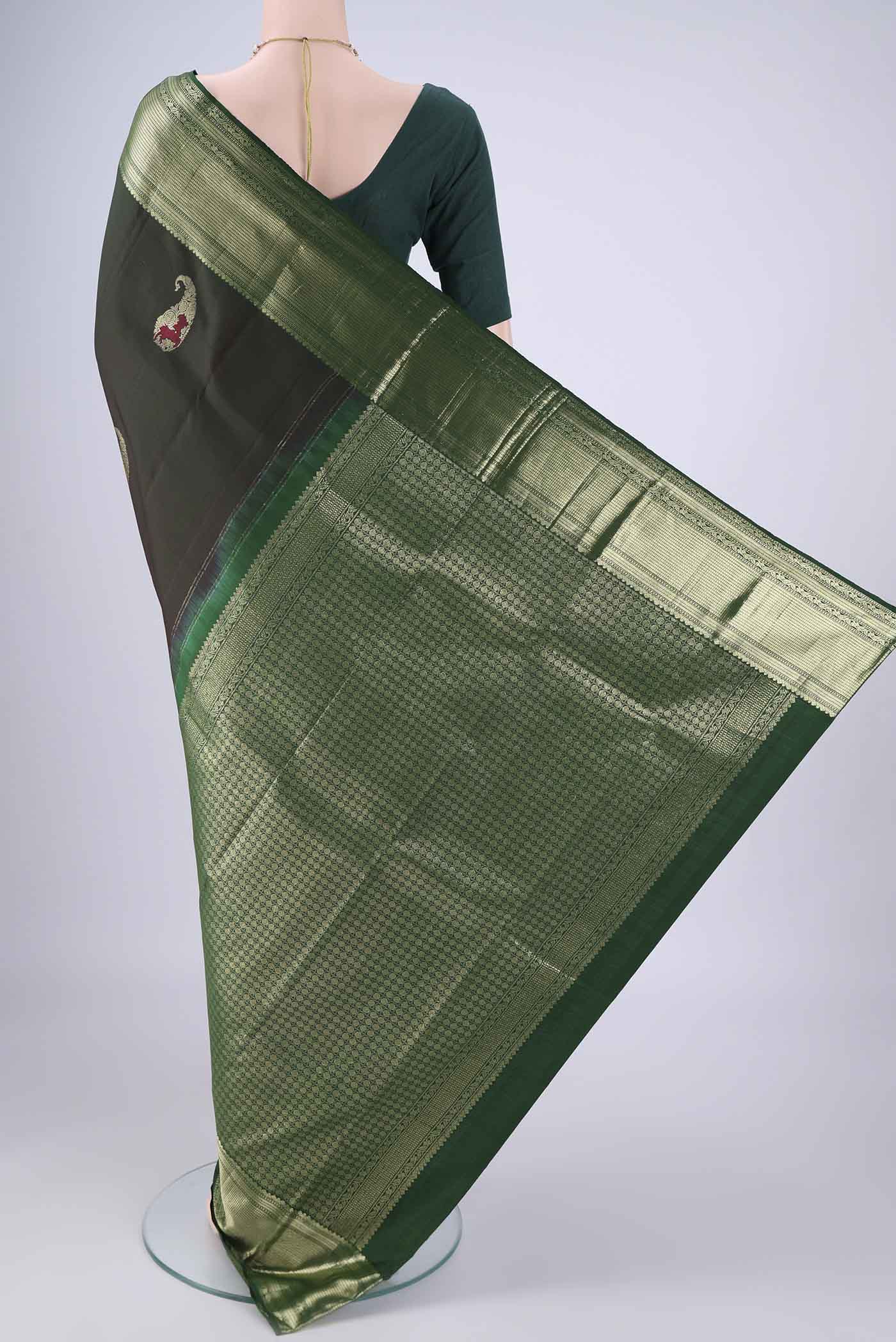 Flat view of Bottle Green Kanjivaram Silk Saree with Zari Butta on the body and Zari Border. 
